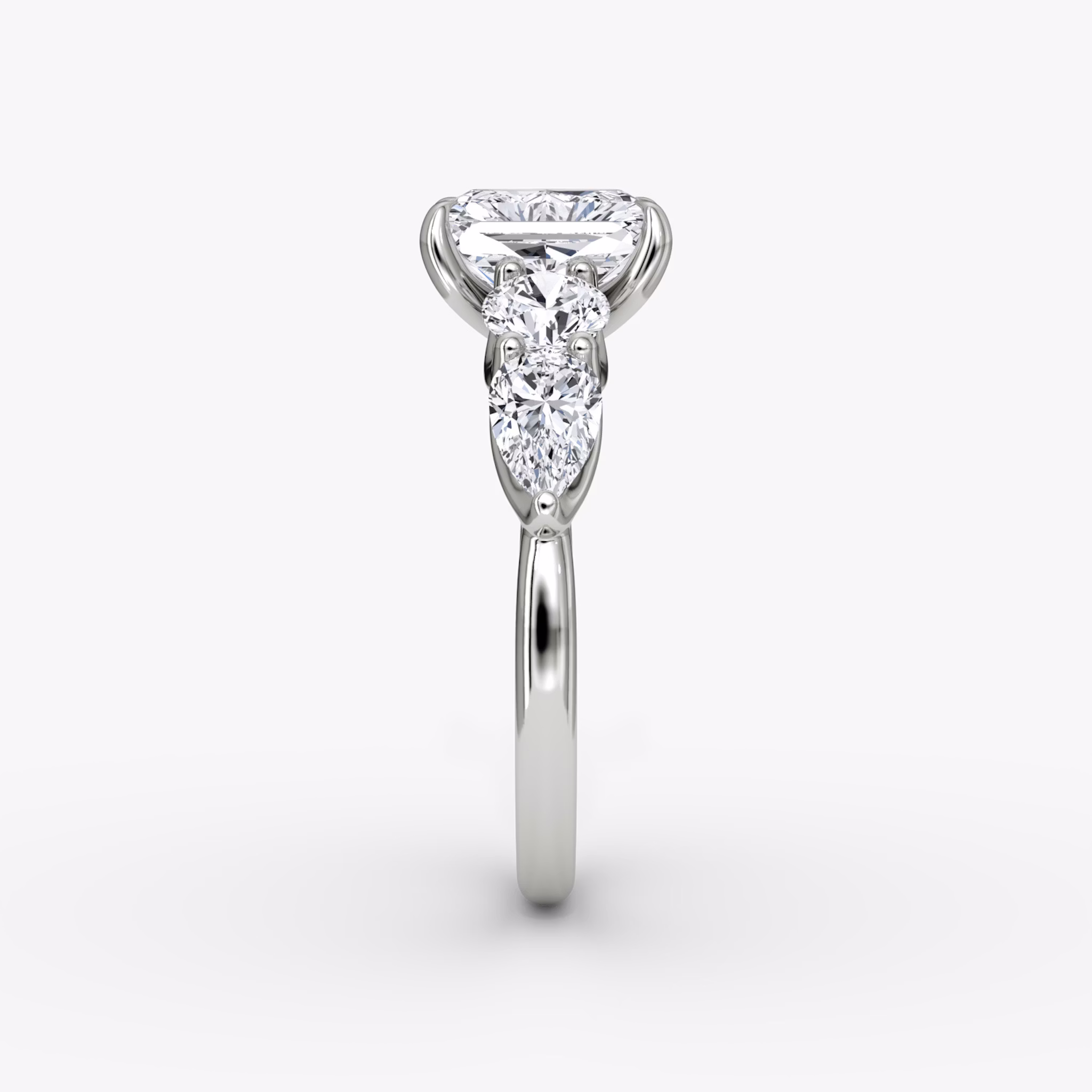 The Mixed Shape | Radiant | 18k | White Gold | bandAccent: Plain | sideStoneOrientation: horizontal | sideStoneShape: Round Brilliant and Pear | diamondOrientation: vertical | caratWeight: other
