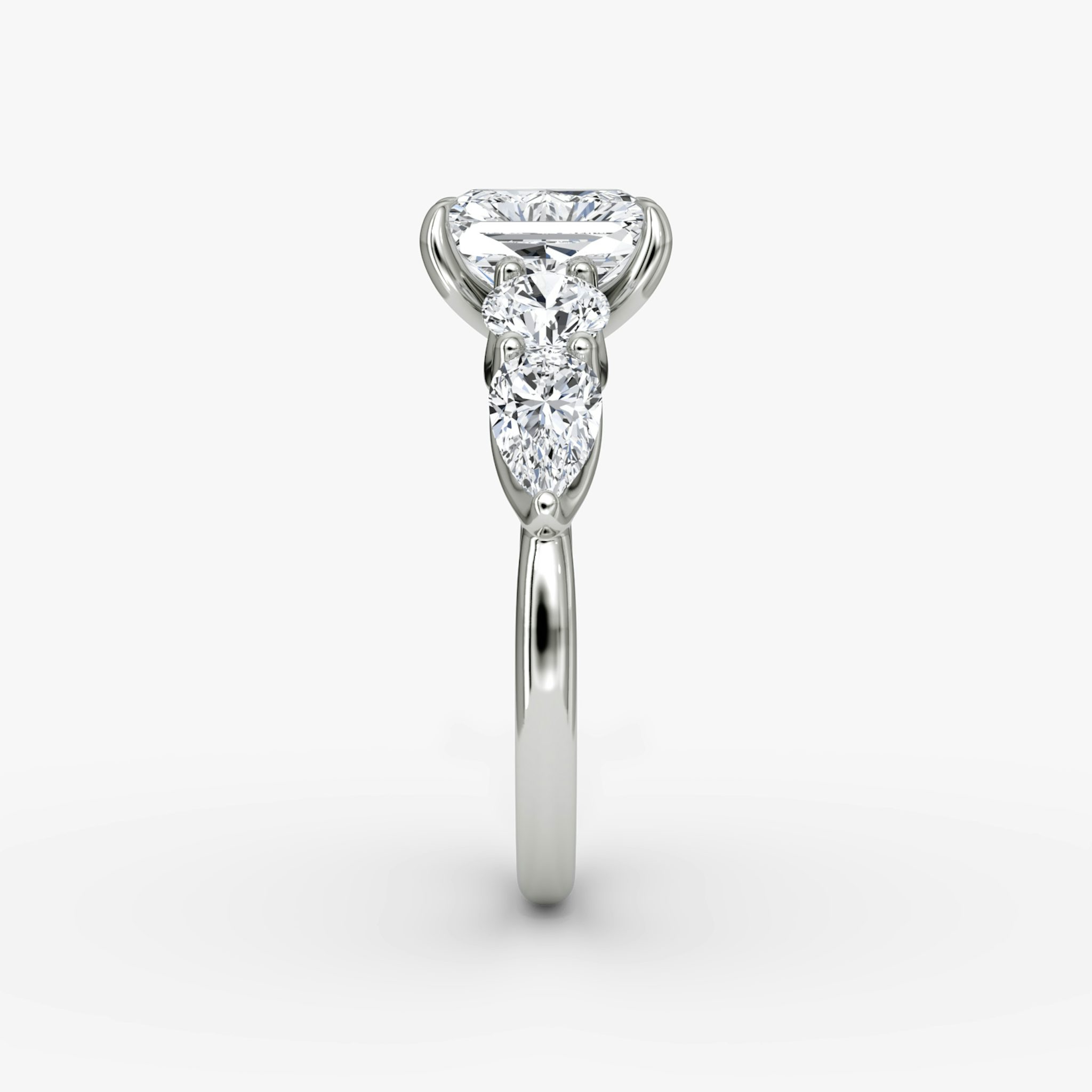 The Mixed Shape | Radiant | 18k | White Gold | bandAccent: Plain | sideStoneOrientation: horizontal | sideStoneShape: Round Brilliant and Pear | diamondOrientation: vertical | caratWeight: other