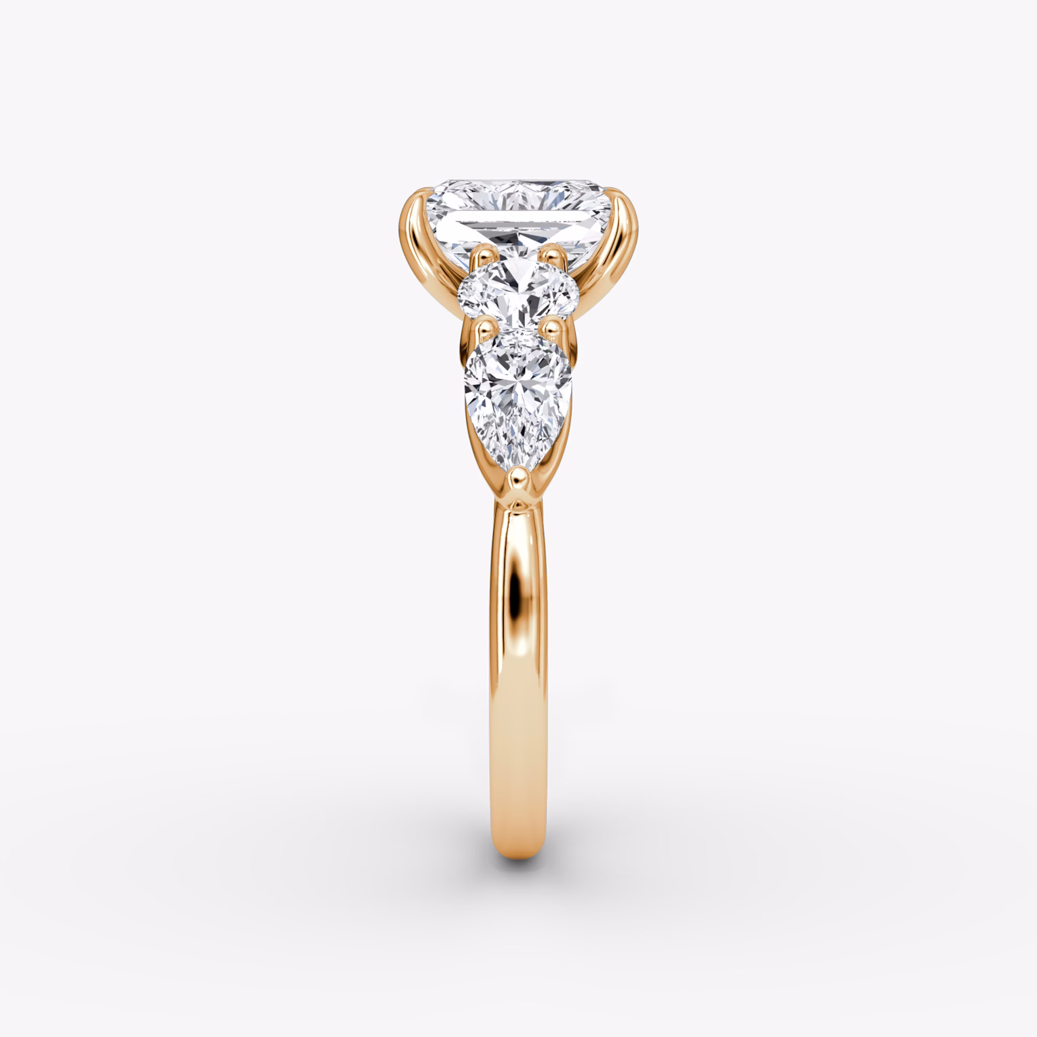 The Mixed Shape | Radiant | 14k | Rose Gold | bandAccent: Plain | sideStoneOrientation: horizontal | sideStoneShape: Round Brilliant and Pear | diamondOrientation: vertical | caratWeight: other