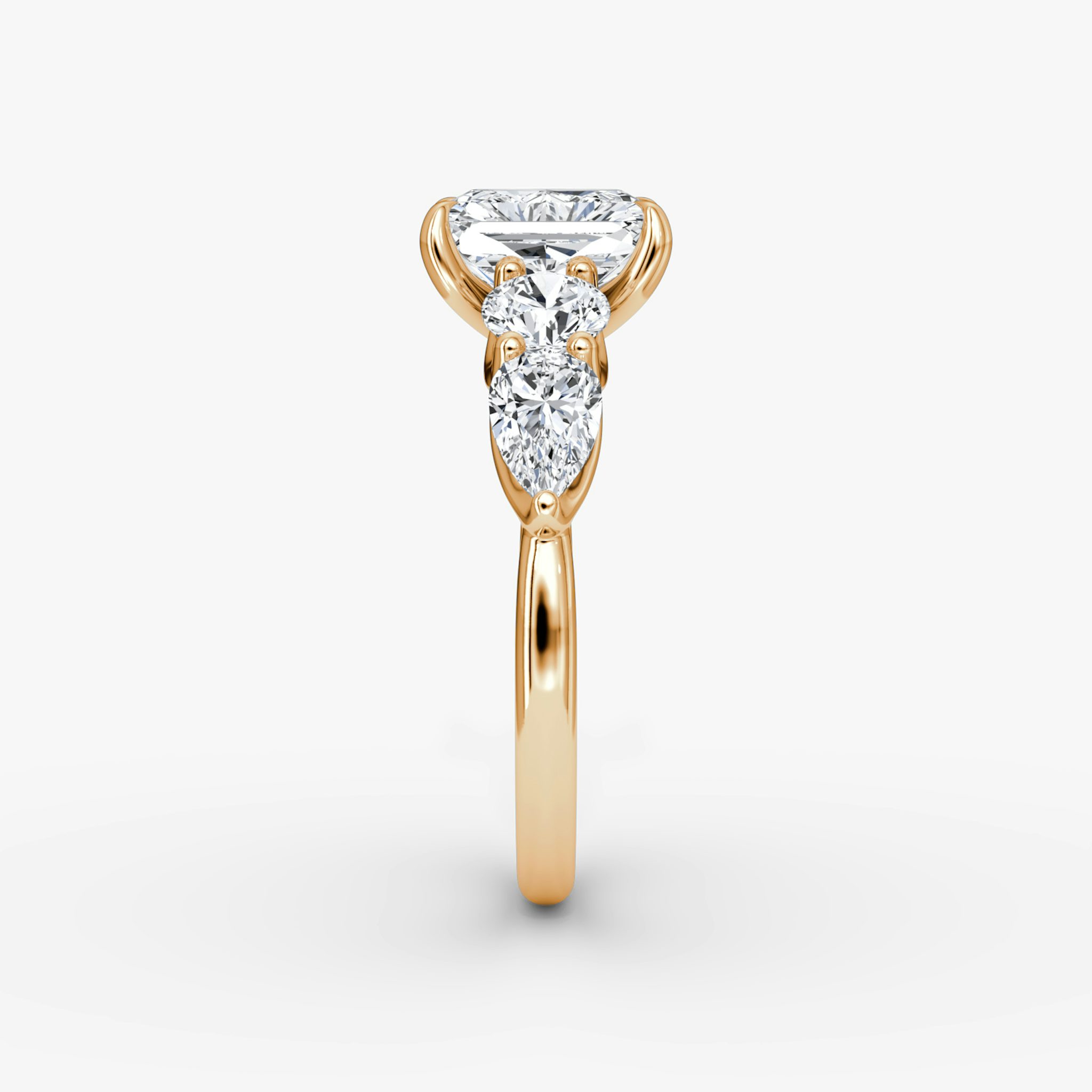 The Mixed Shape | Radiant | 14k | Rose Gold | bandAccent: Plain | sideStoneOrientation: horizontal | sideStoneShape: Round Brilliant and Pear | diamondOrientation: vertical | caratWeight: other