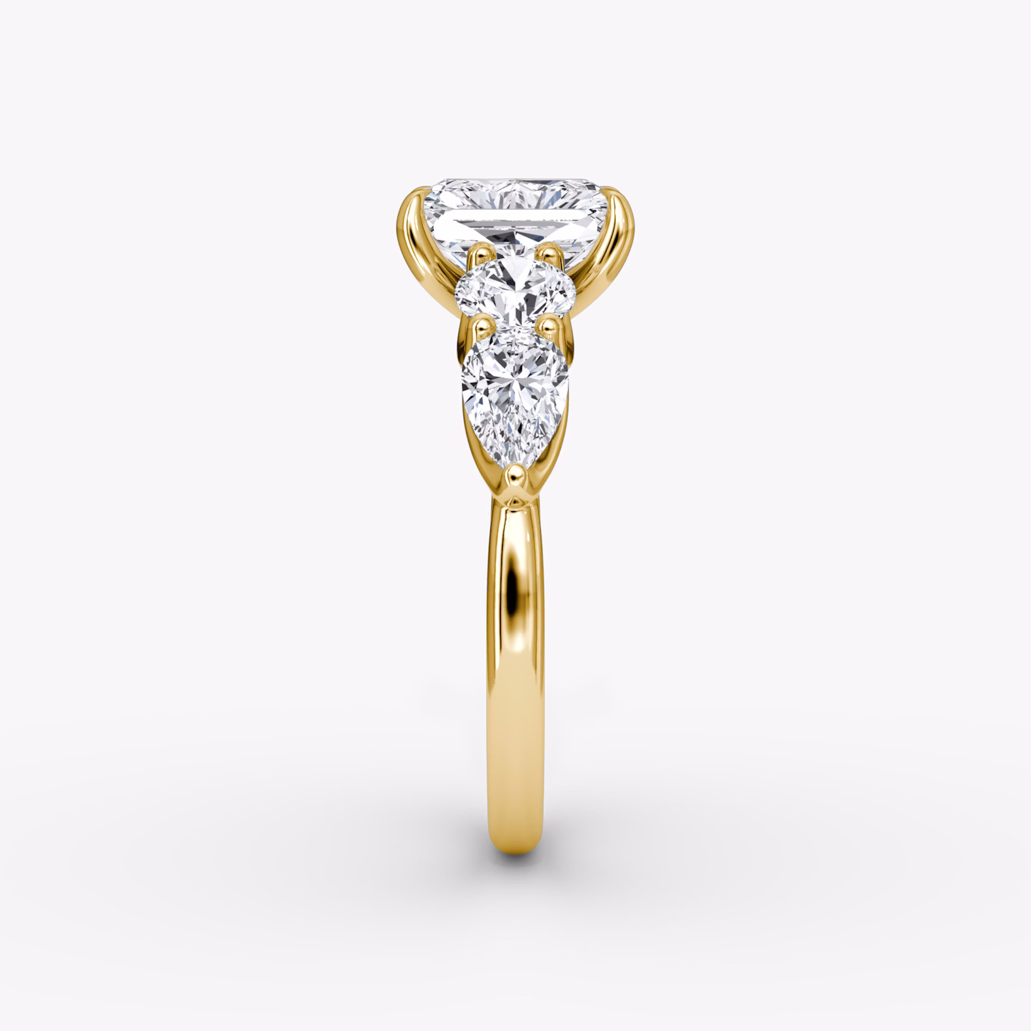The Mixed Shape | Radiant | 18k | Yellow Gold | bandAccent: Plain | sideStoneOrientation: horizontal | sideStoneShape: Round Brilliant and Pear | diamondOrientation: vertical | caratWeight: other