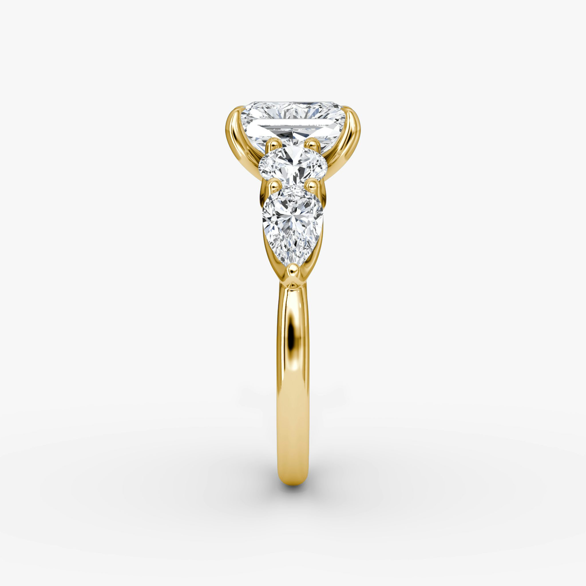 The Mixed Shape | Radiant | 18k | Yellow Gold | bandAccent: Plain | sideStoneOrientation: horizontal | sideStoneShape: Round Brilliant and Pear | diamondOrientation: vertical | caratWeight: other