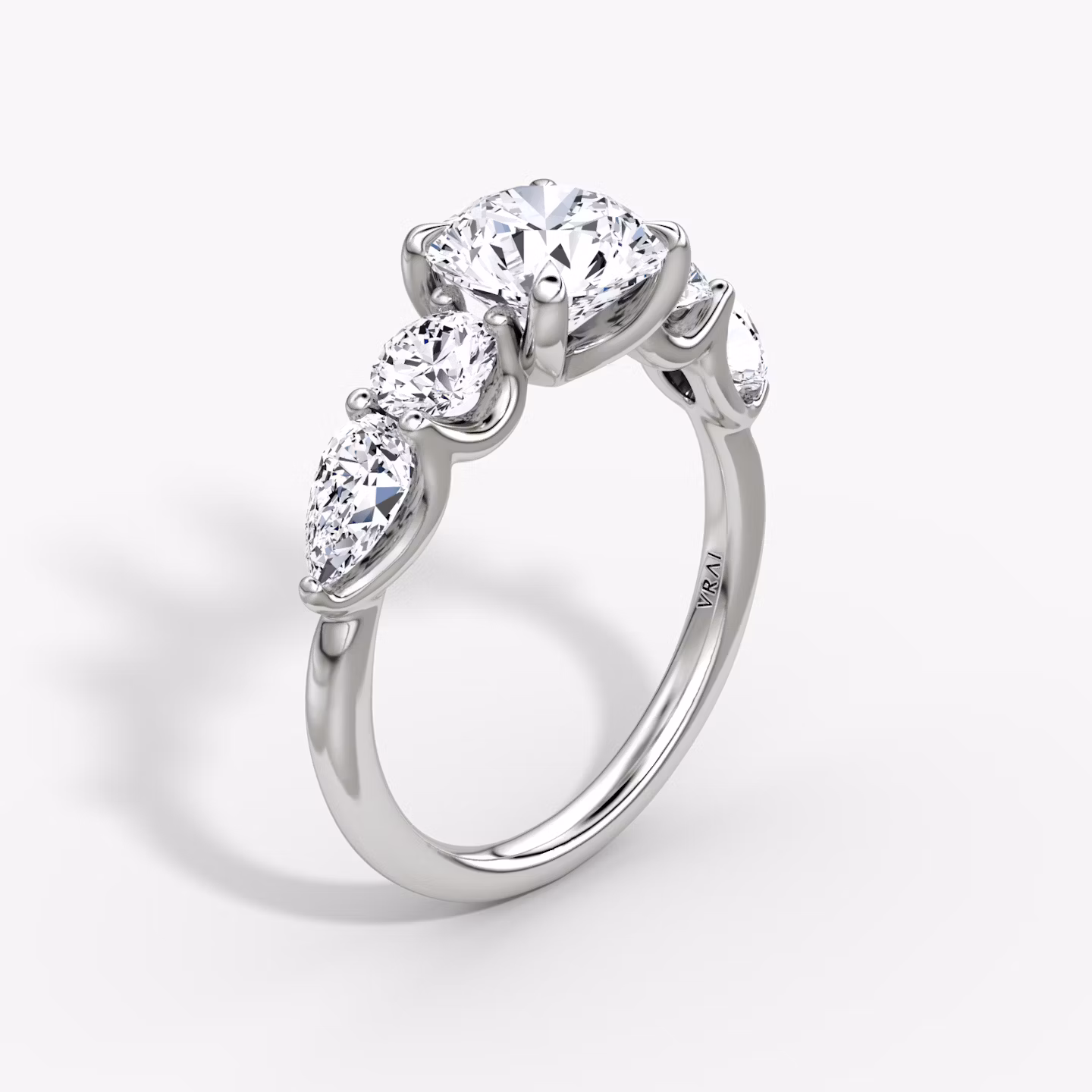 The Mixed Shape | Round Brilliant | 18k | White Gold | bandAccent: Plain | caratWeight: 1.0ct | sideStoneOrientation: horizontal | sideStoneShape: Round Brilliant and Pear | diamondOrientation: vertical