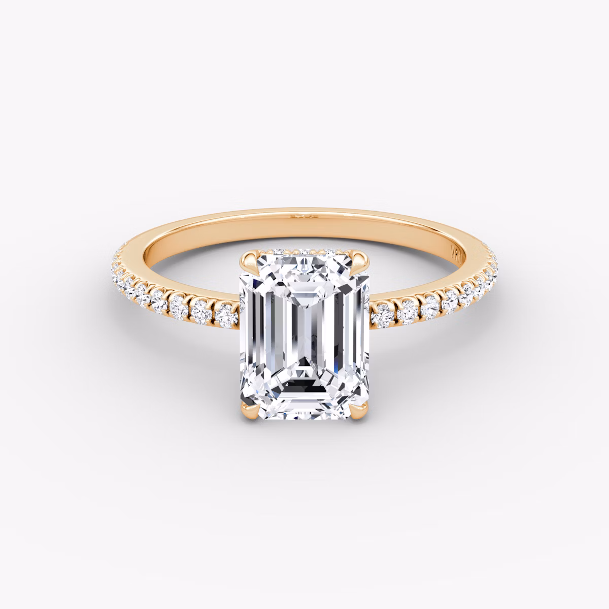 Emerald-cut diamond ring with hidden halo and pavé band in rose gold, VRAI Signature Hidden Halo setting.