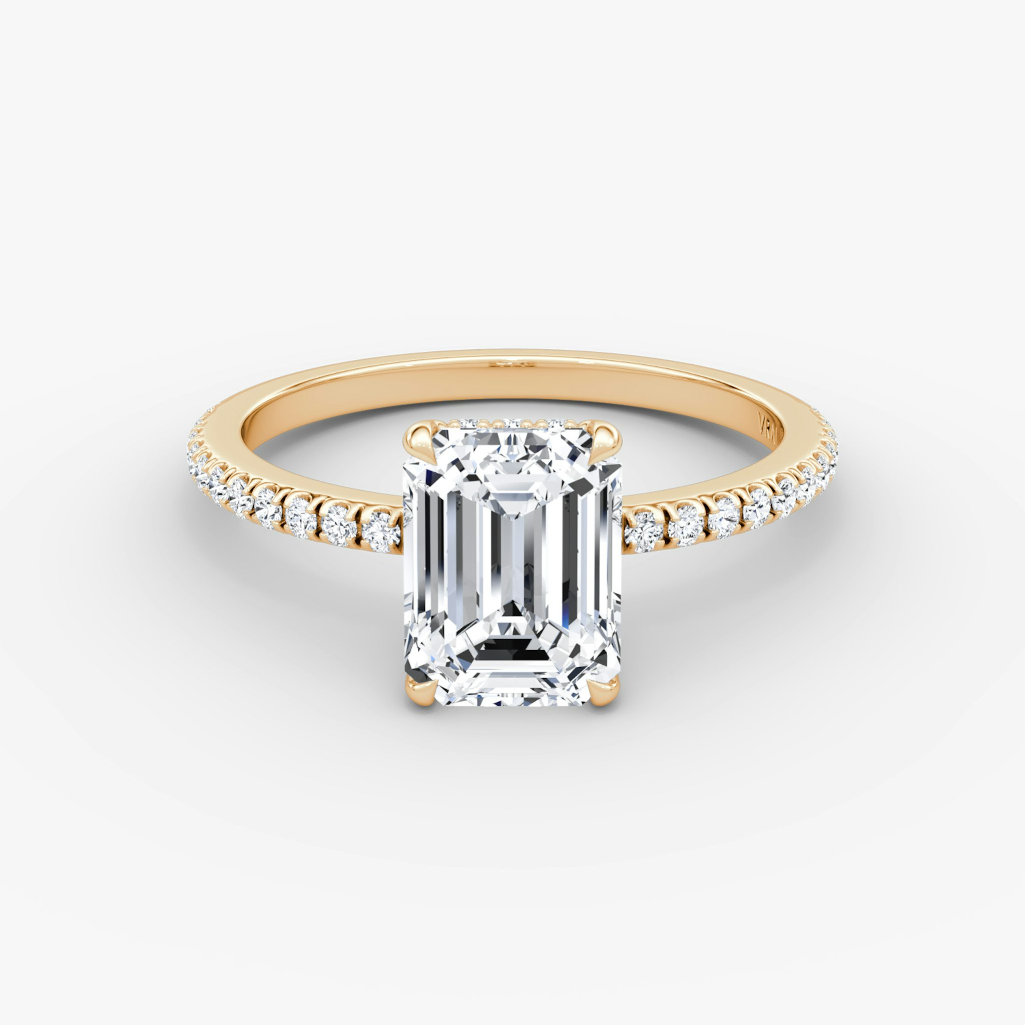 Emerald-cut diamond ring with hidden halo and pavé band in rose gold, VRAI Signature Hidden Halo setting.