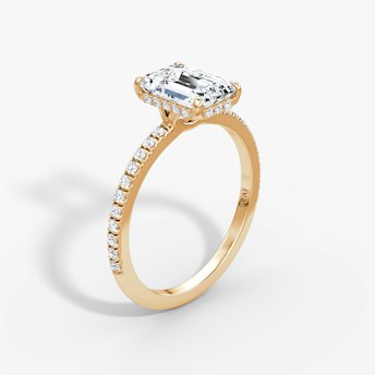 Emerald-cut diamond ring with hidden halo and pavé band in rose gold, VRAI Signature Hidden Halo setting..