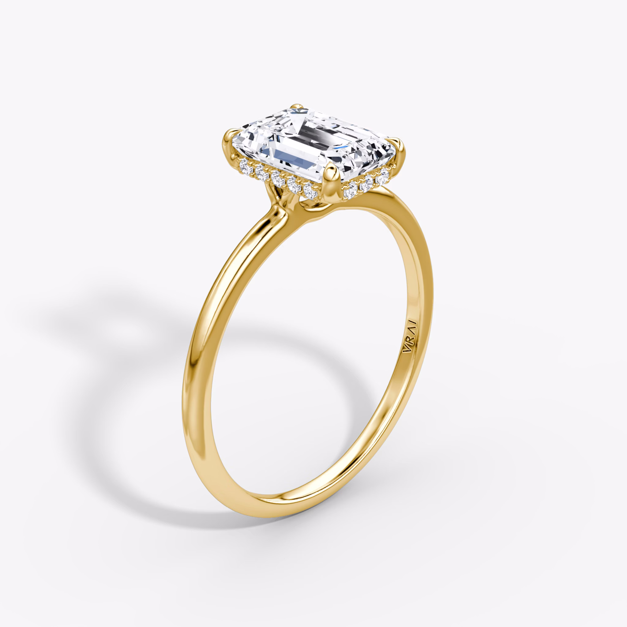Upright emerald engagement ring with a slim 2-1mm plain yellow gold band, featuring a classic and minimalist design.