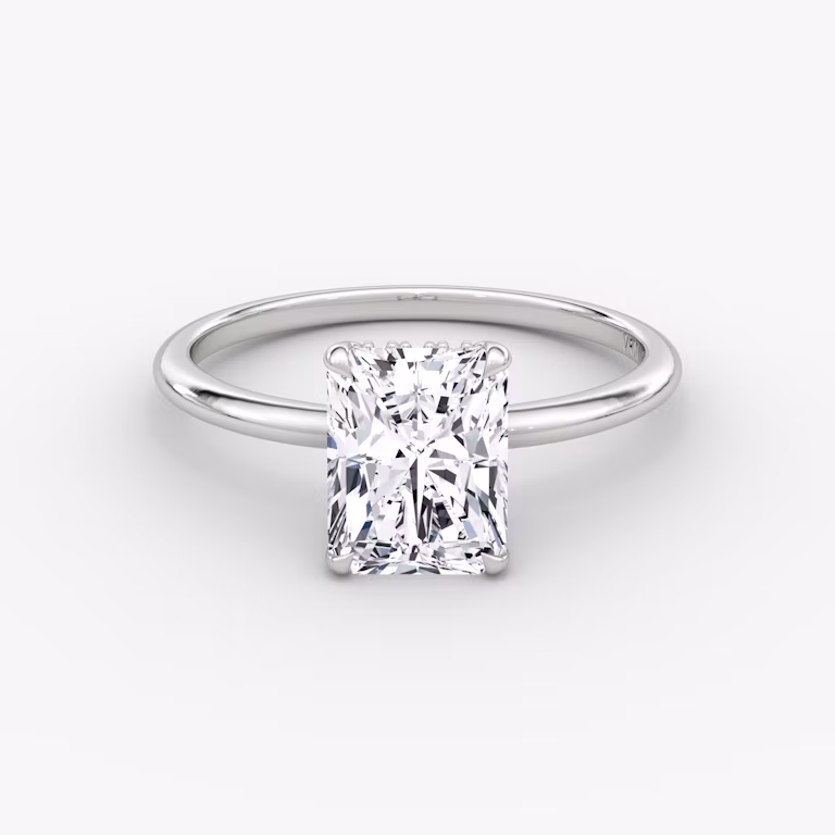 Radiant-cut diamond ring with hidden halo and plain platinum band, VRAI Signature Hidden Halo setting.