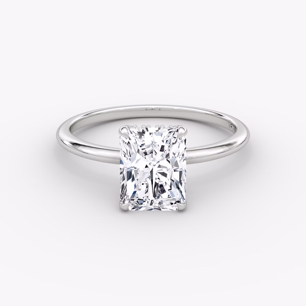 Radiant-cut diamond ring with hidden halo and plain platinum band, VRAI Signature Hidden Halo setting.