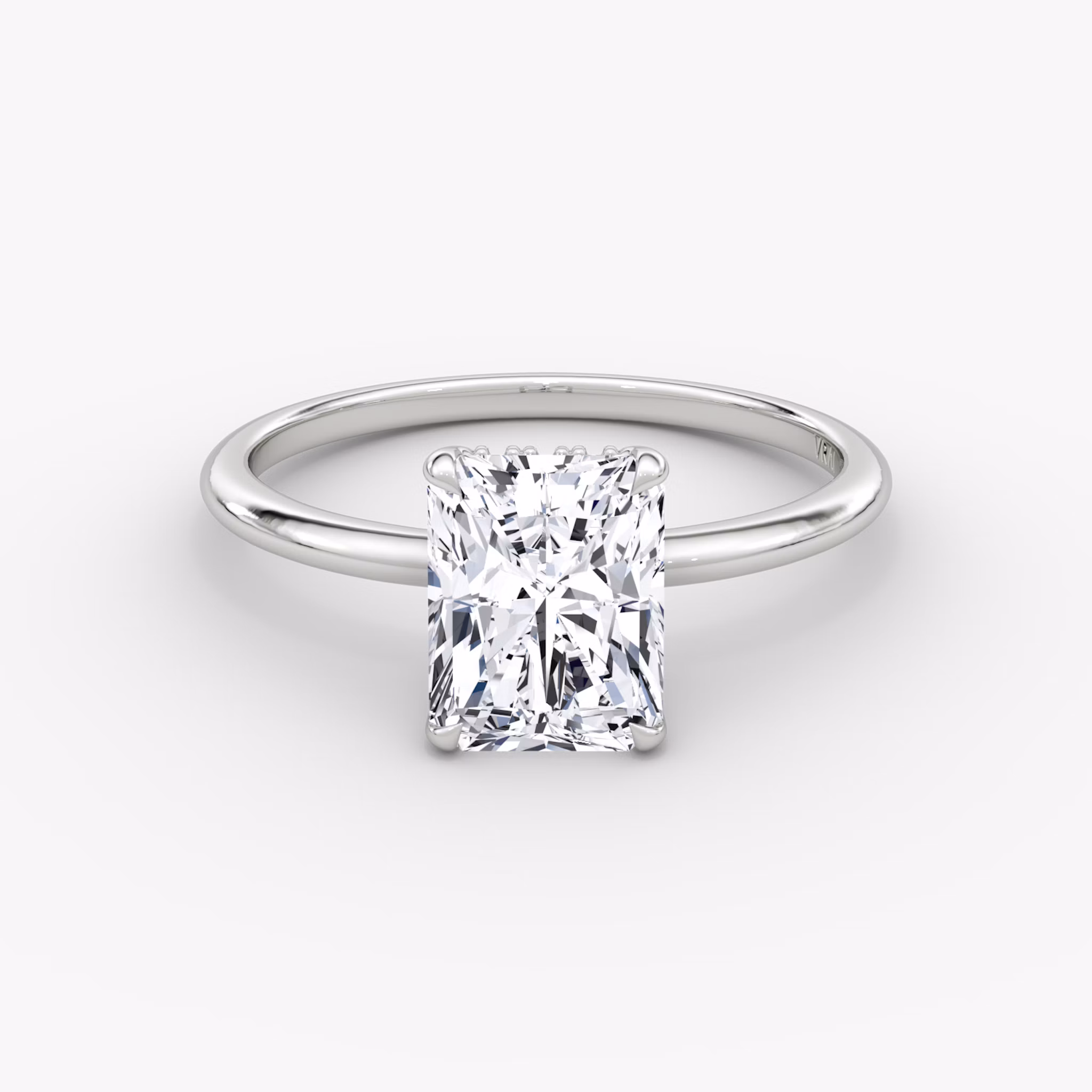 Radiant-cut diamond ring with hidden halo and plain platinum band, VRAI Signature Hidden Halo setting.