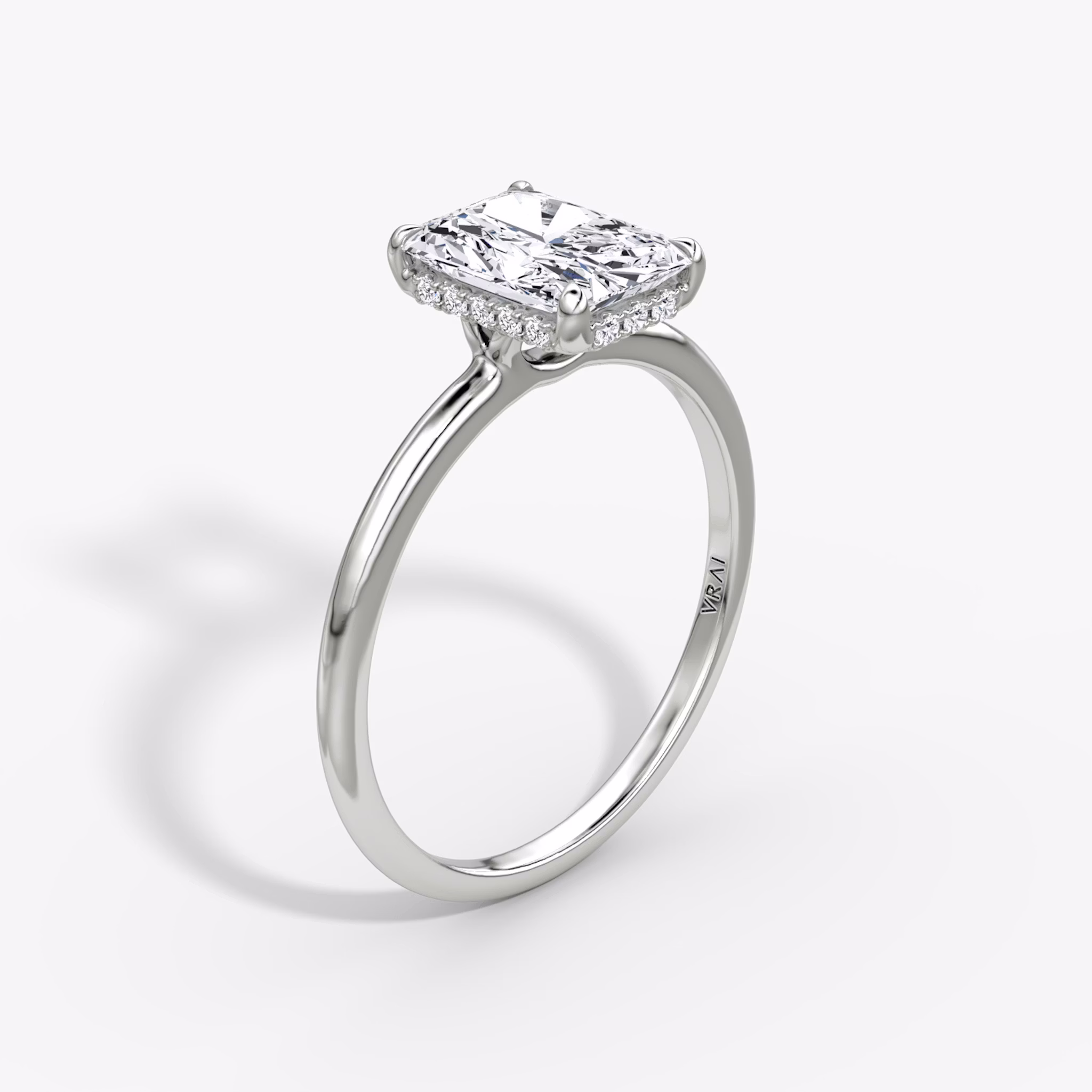 Radiant-cut diamond ring with hidden halo and plain platinum band, VRAI Signature Hidden Halo setting.