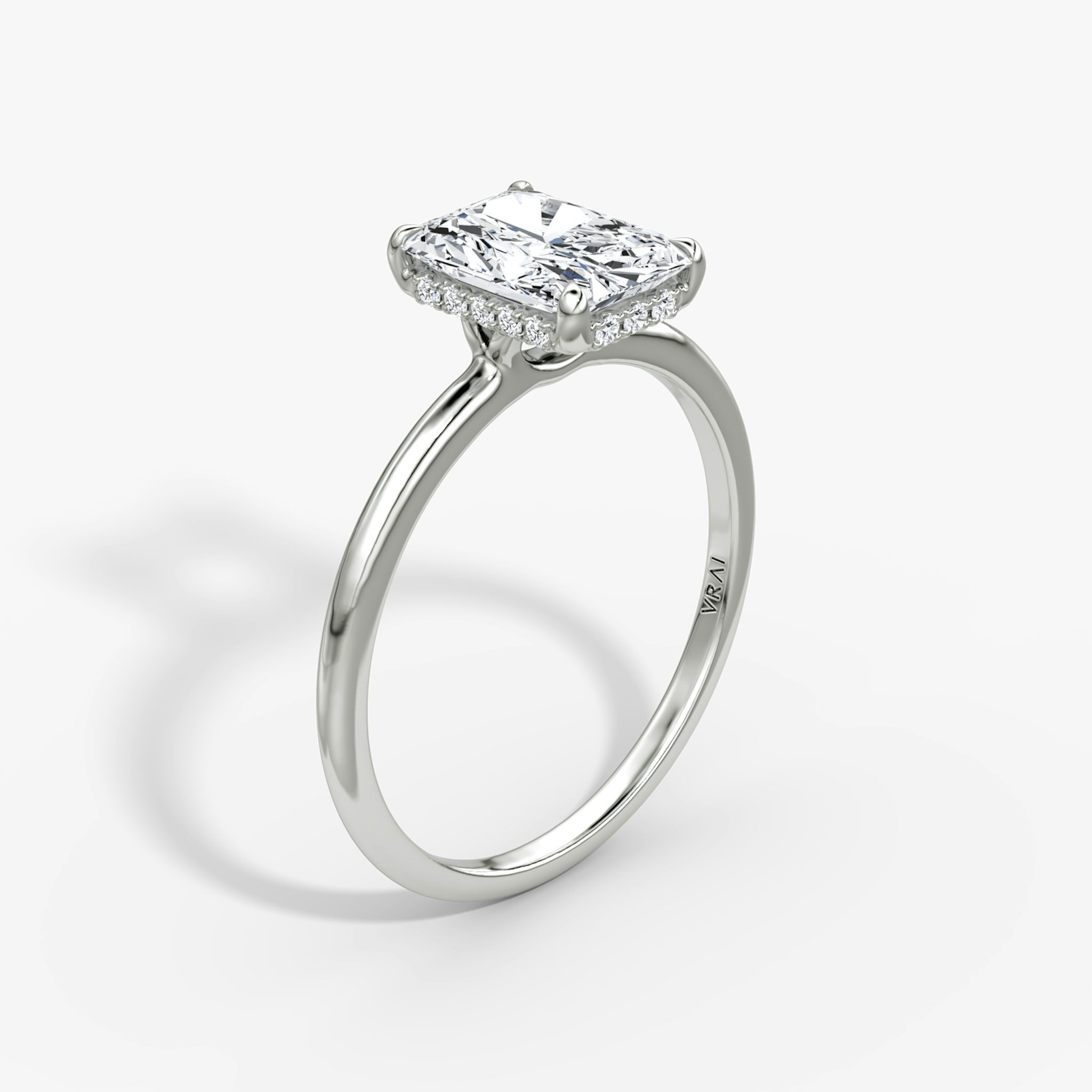 Radiant-cut diamond ring with hidden halo and plain platinum band, VRAI Signature Hidden Halo setting.