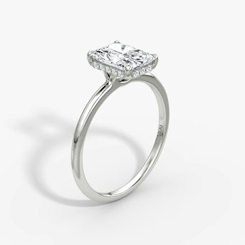 Radiant-cut diamond ring with hidden halo and plain platinum band, VRAI Signature Hidden Halo setting.