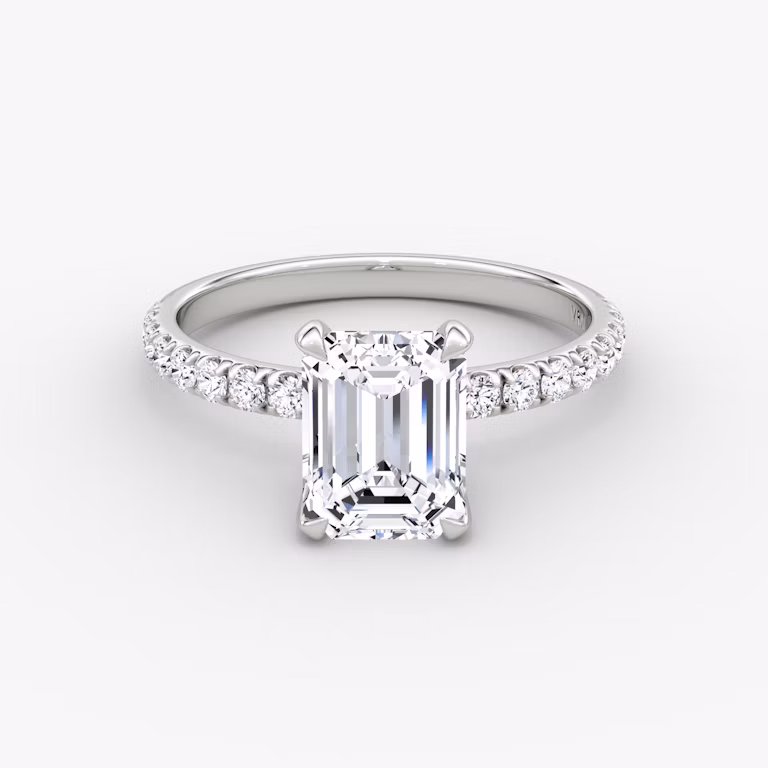 Emerald-cut diamond ring with 2.1mm pavé band in white gold, showcasing a classic engagement style with refined brilliance.