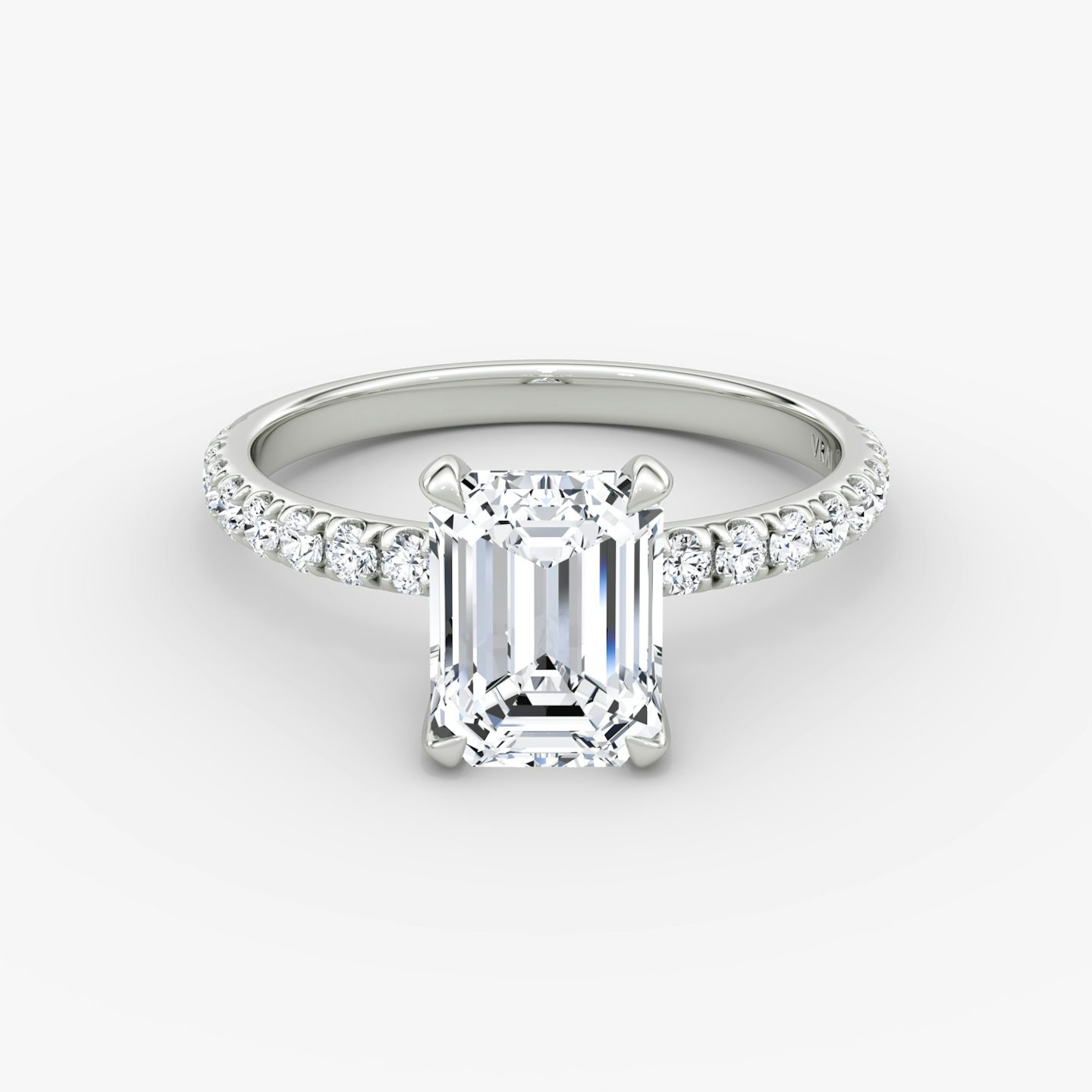 Emerald-cut diamond ring with 2.1mm pavé band in white gold, showcasing a classic engagement style with refined brilliance.