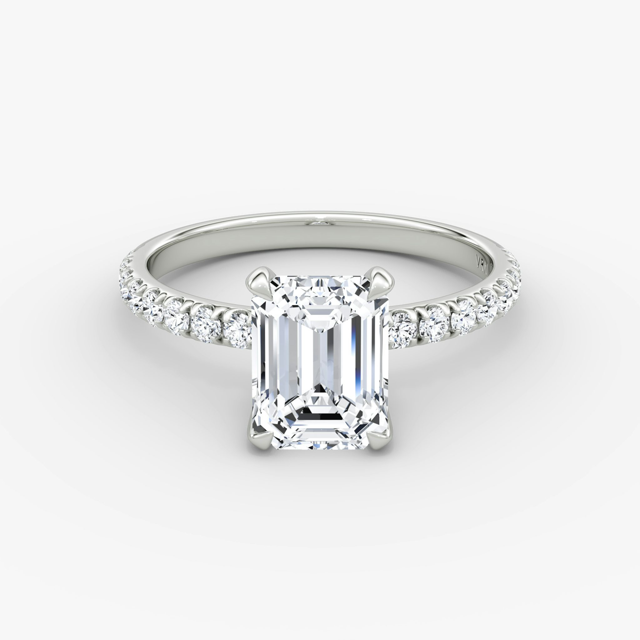 Emerald-cut diamond ring with 2.1mm pavé band in white gold, showcasing a classic engagement style with refined brilliance.