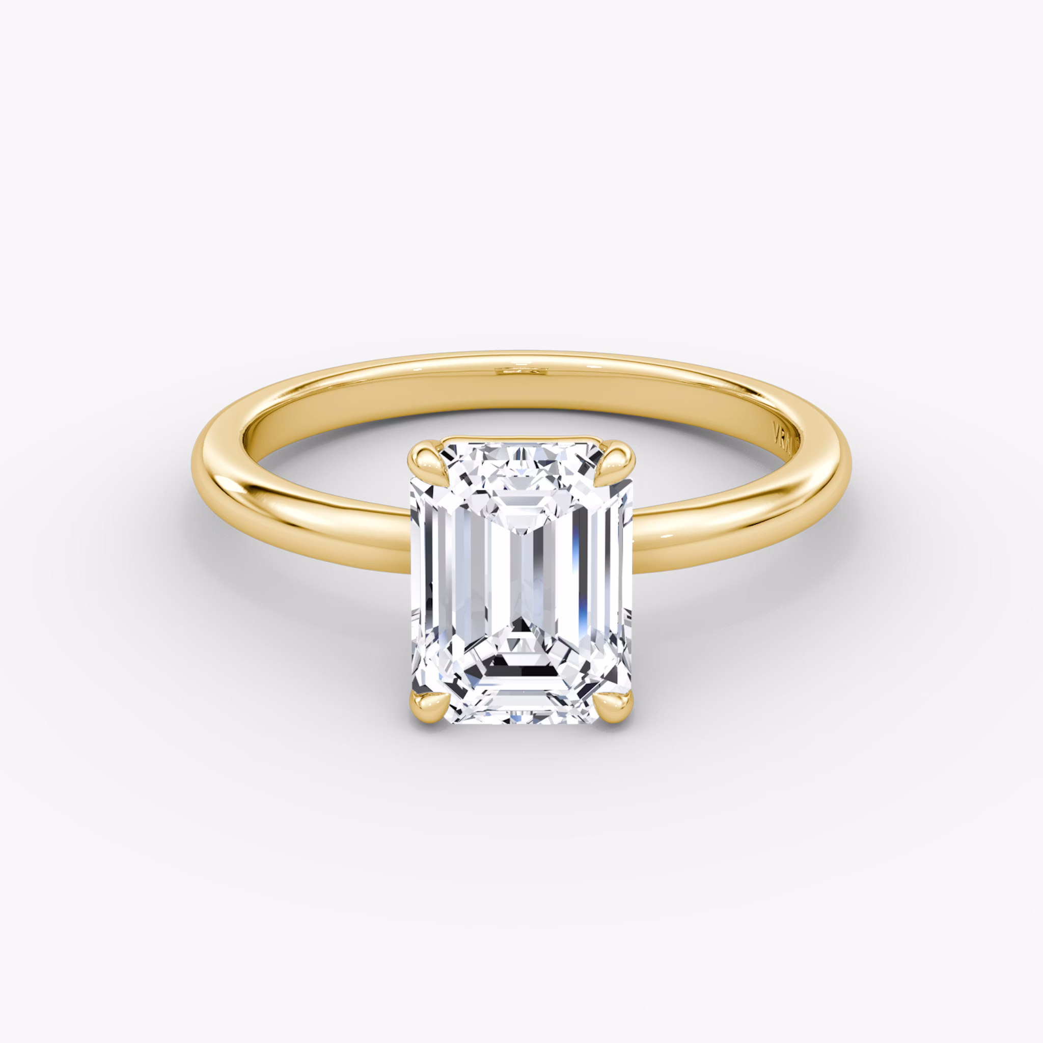 Emerald-cut diamond solitaire engagement ring with a 2.1mm yellow gold band, shown from the front view.
