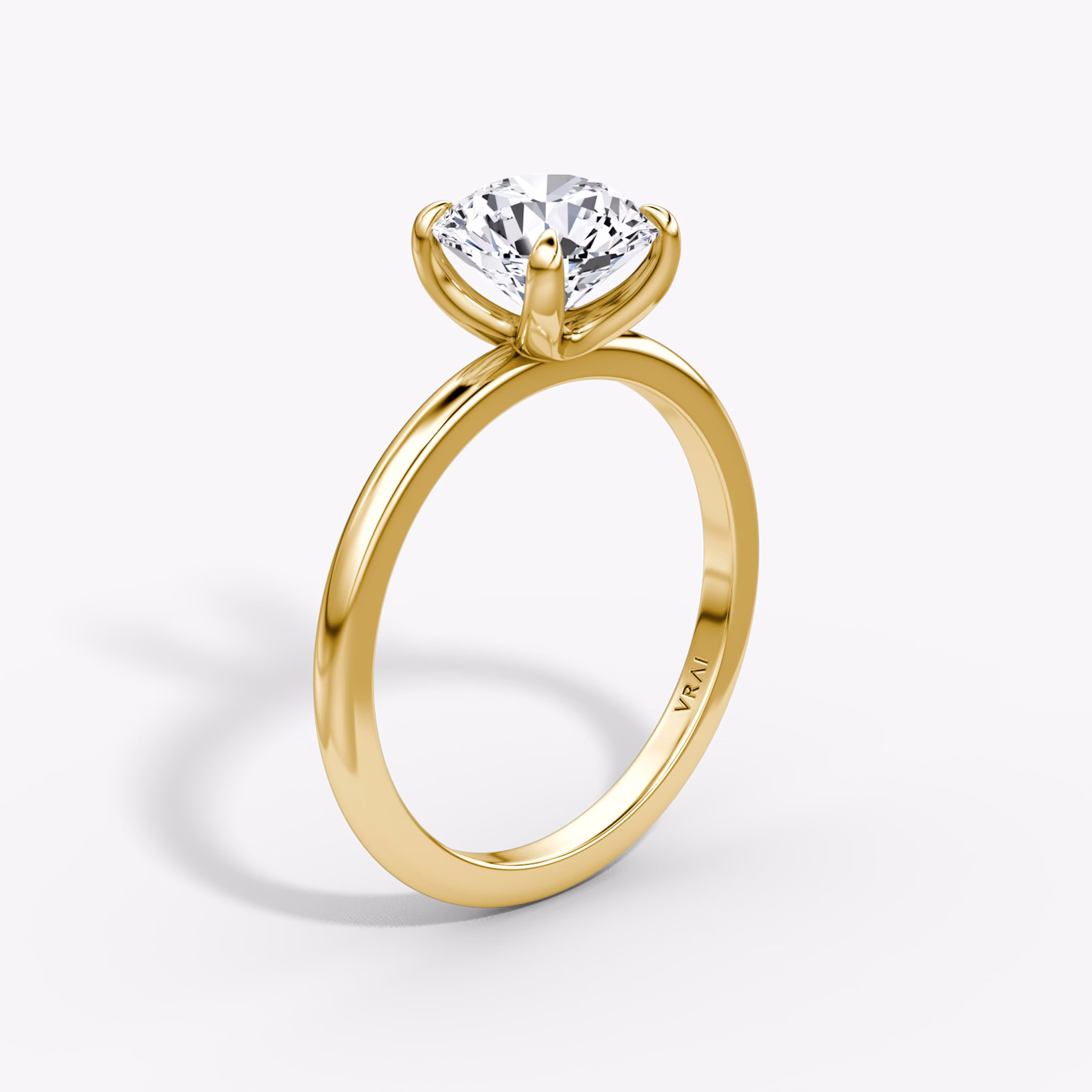 Round brilliant diamond engagement ring in yellow gold with a classic 4-prong dome setting, designed by VRAI.