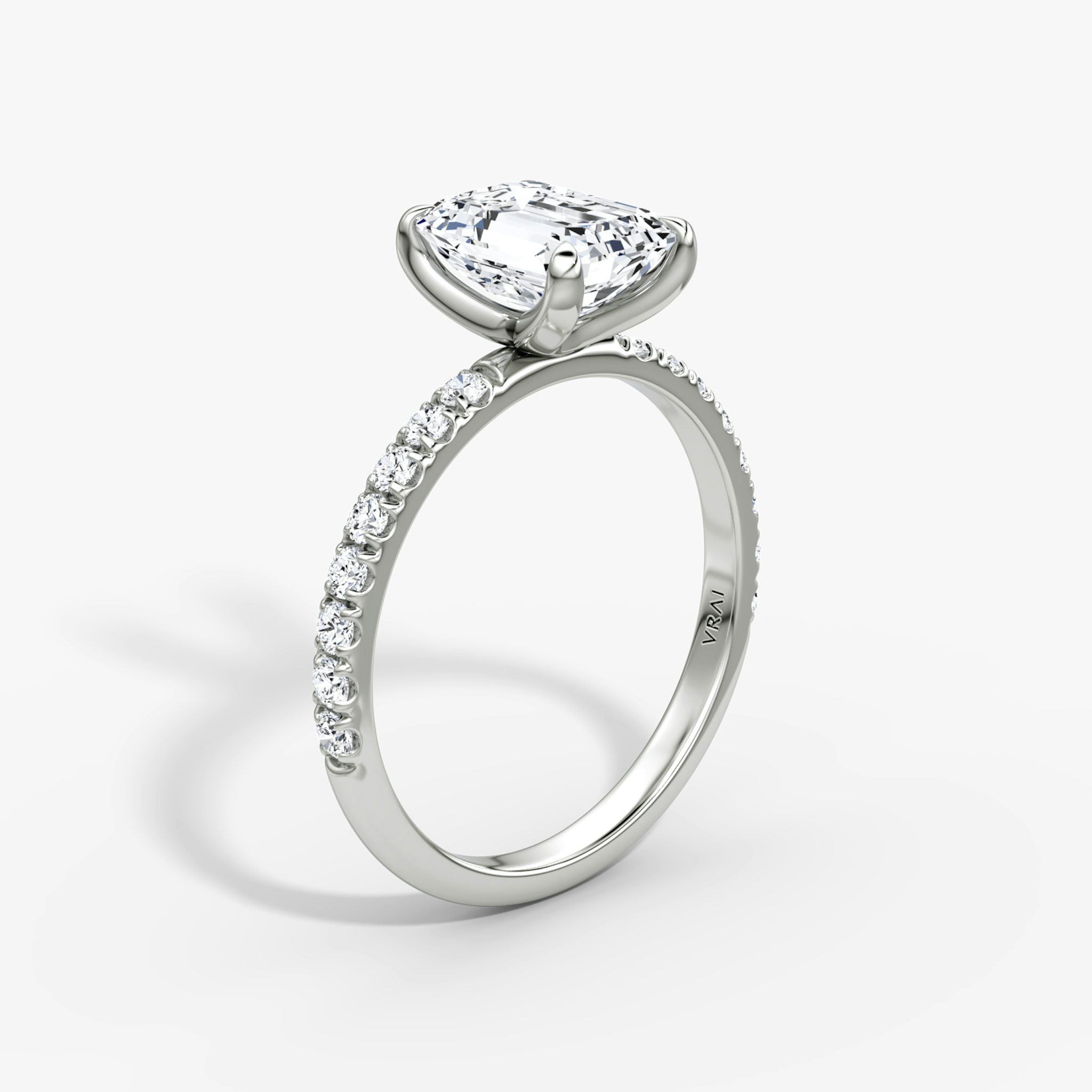 Upright emerald-cut diamond ring with 2.1mm pavé band in white gold, showcasing a classic engagement style with refined brilliance.