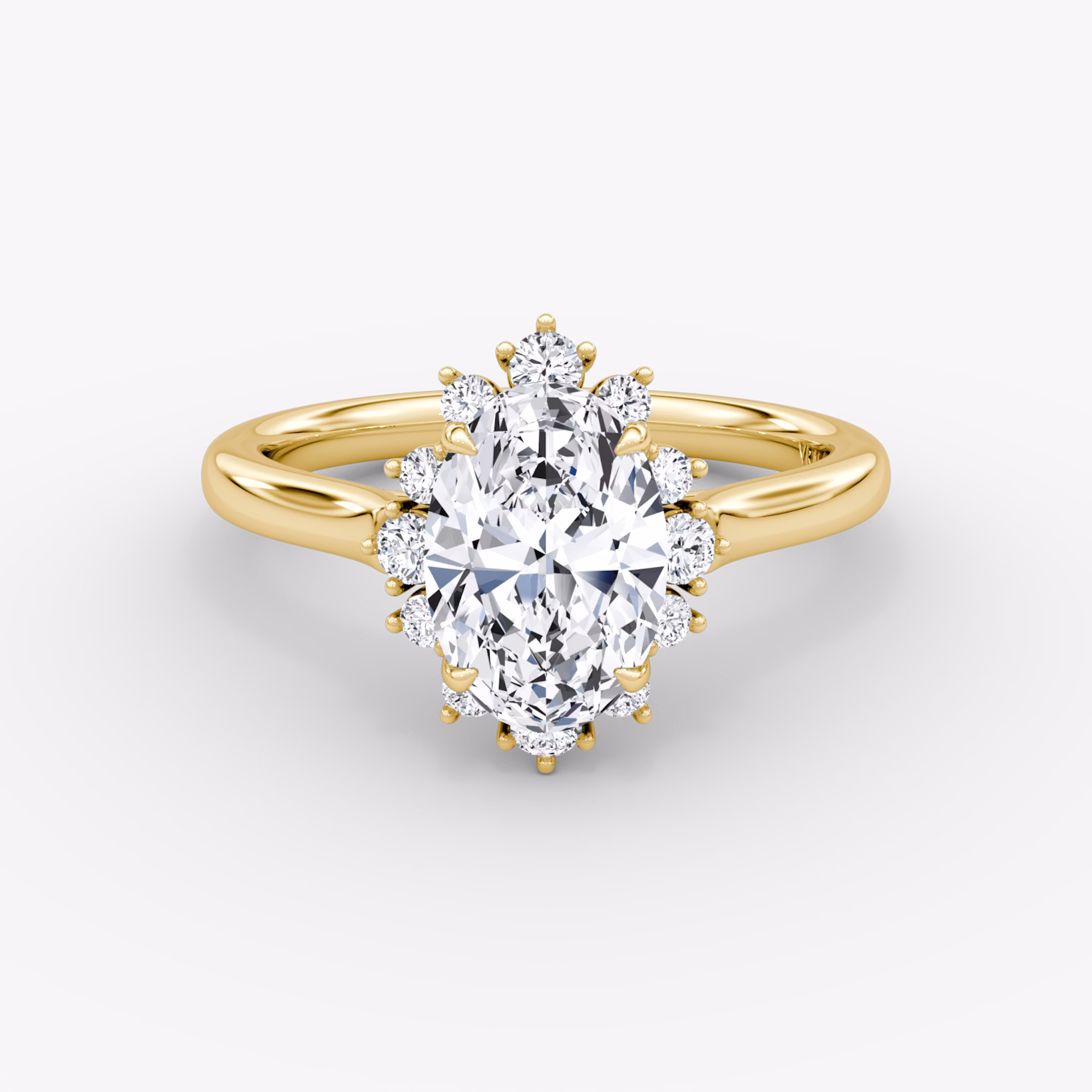 A close-up image of VRAI's Aurora Halo Oval Yellow Gold Engagement Ring, lying flat.