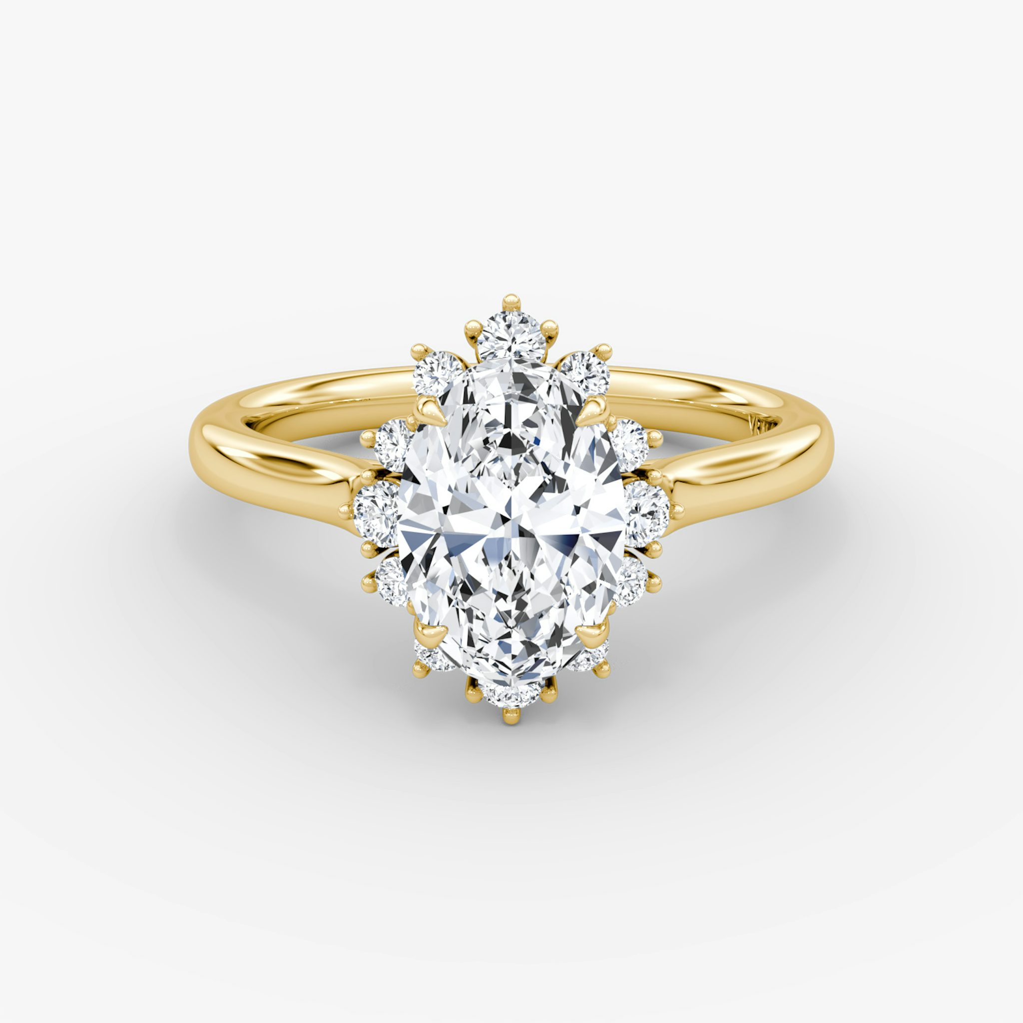 A close-up image of VRAI's Aurora Halo Oval Yellow Gold Engagement Ring, lying flat.