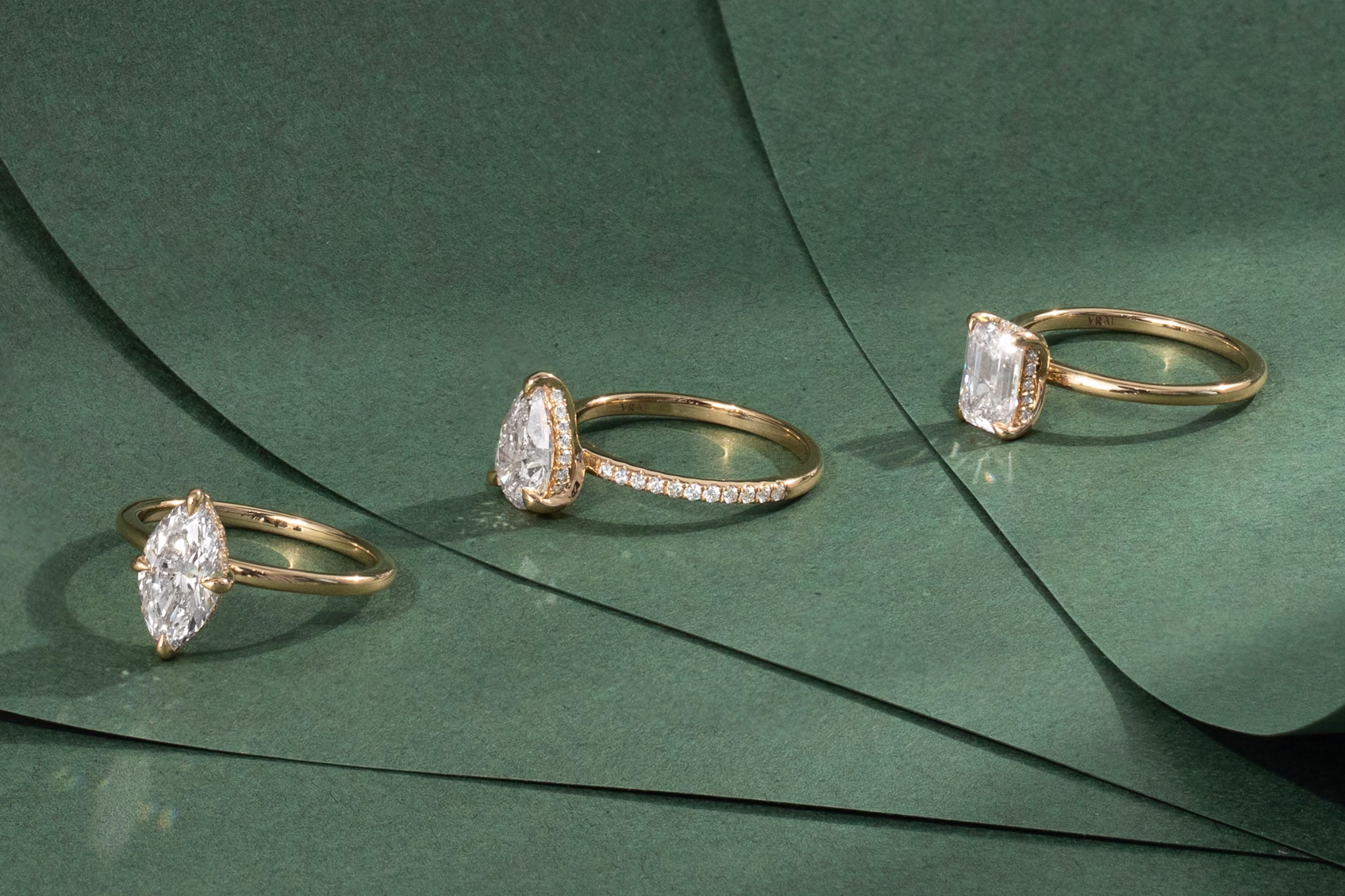 three made to order engagement rings with emerald cut, pear cut and marquise cut lab diamonds