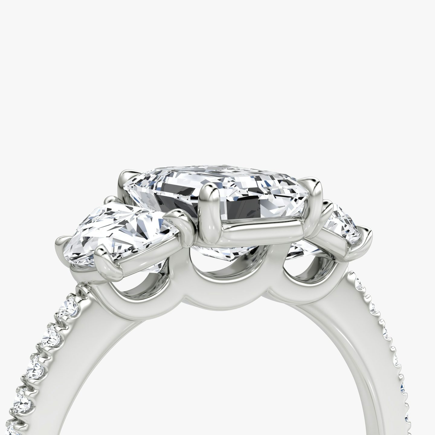 The Three Stone | Emerald | Platinum | bandAccent: Pavé | sideStoneCarat: 0.50ct | sideStoneShape: Half Moon | diamondOrientation: vertical | caratWeight: other
