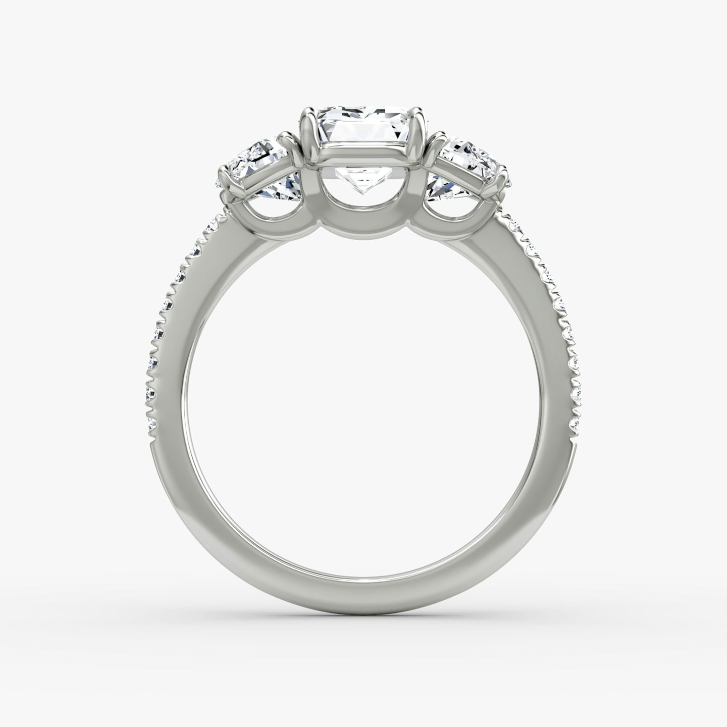 The Three Stone | Emerald | Platinum | bandAccent: Pavé | sideStoneCarat: 0.50ct | sideStoneShape: Half Moon | diamondOrientation: vertical | caratWeight: other