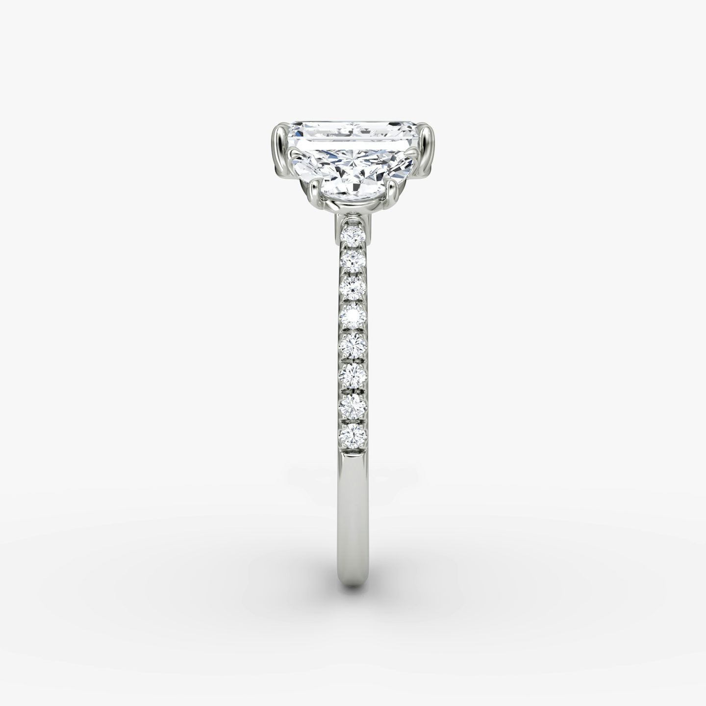The Three Stone | Emerald | Platinum | bandAccent: Pavé | sideStoneCarat: 0.50ct | sideStoneShape: Half Moon | diamondOrientation: vertical | caratWeight: other