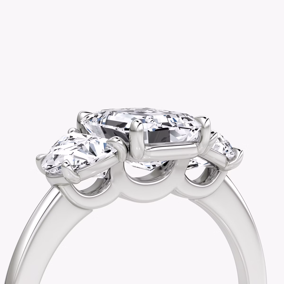 The Three Stone | Emerald | Platinum | bandAccent: Plain | sideStoneCarat: 0.50ct | sideStoneShape: Half Moon | diamondOrientation: vertical | caratWeight: other