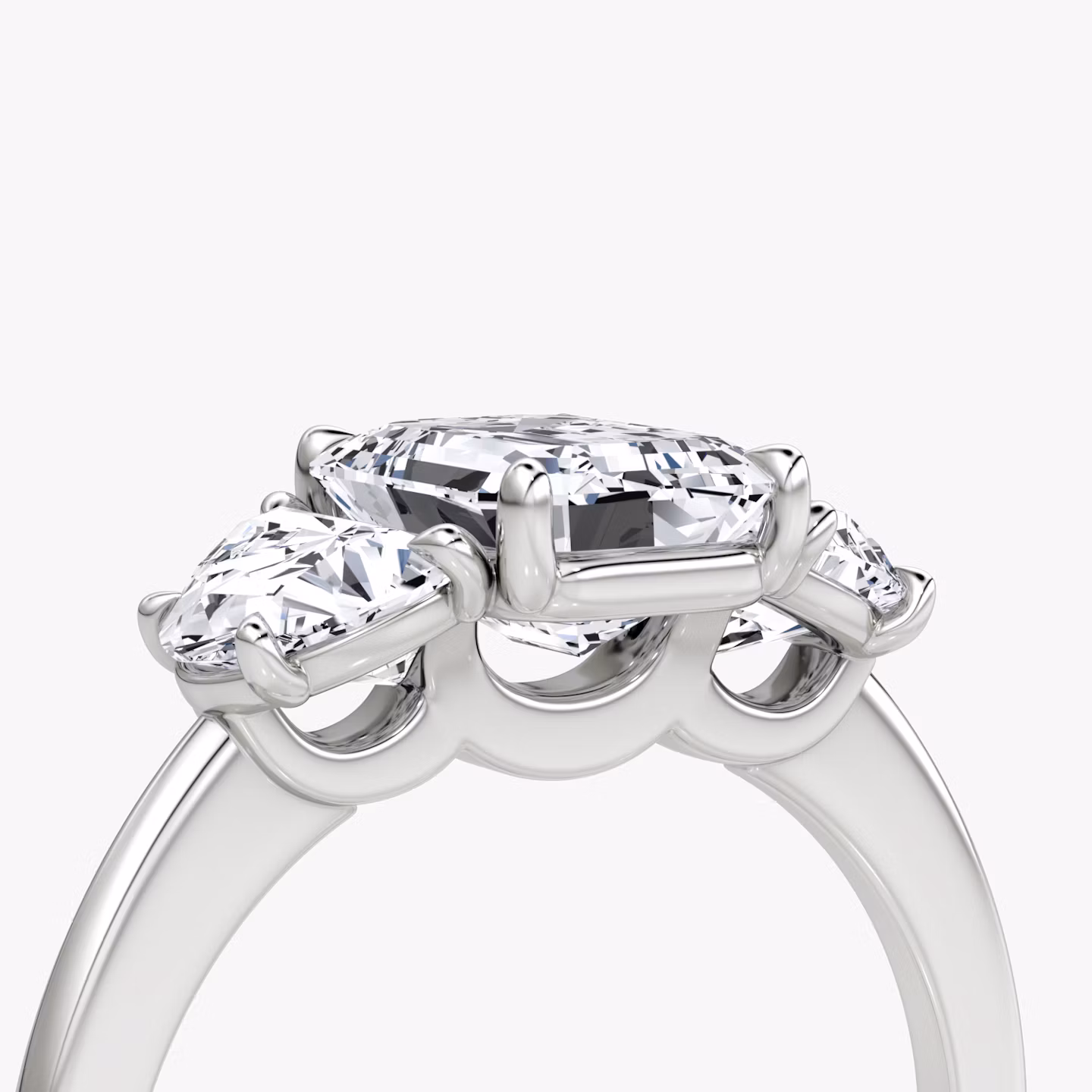 The Three Stone | Emerald | Platinum | bandAccent: Plain | sideStoneCarat: 0.50ct | sideStoneShape: Half Moon | diamondOrientation: vertical | caratWeight: other