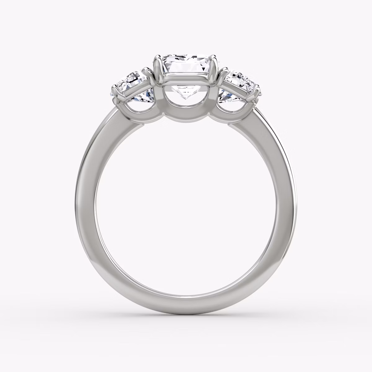 The Three Stone | Emerald | Platinum | bandAccent: Plain | sideStoneCarat: 0.50ct | sideStoneShape: Half Moon | diamondOrientation: vertical | caratWeight: other