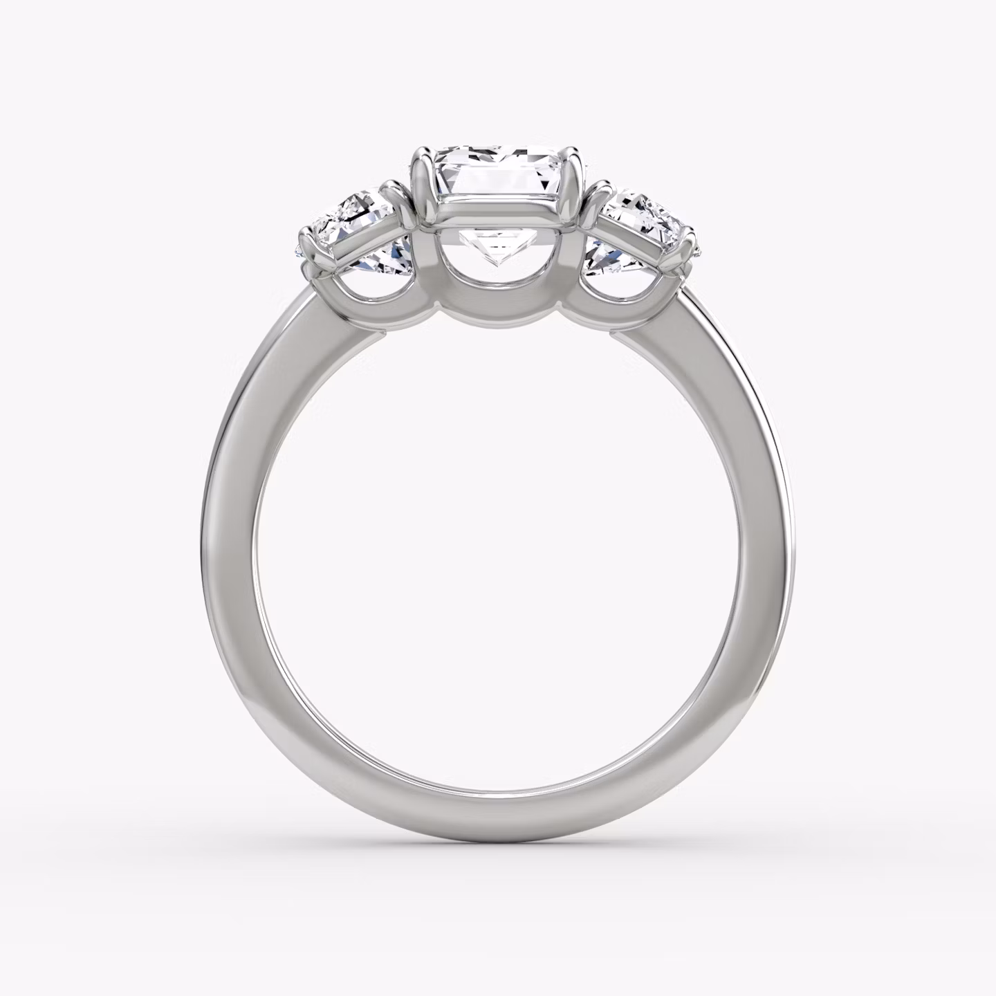 The Three Stone | Emerald | Platinum | bandAccent: Plain | sideStoneCarat: 0.50ct | sideStoneShape: Half Moon | diamondOrientation: vertical | caratWeight: other