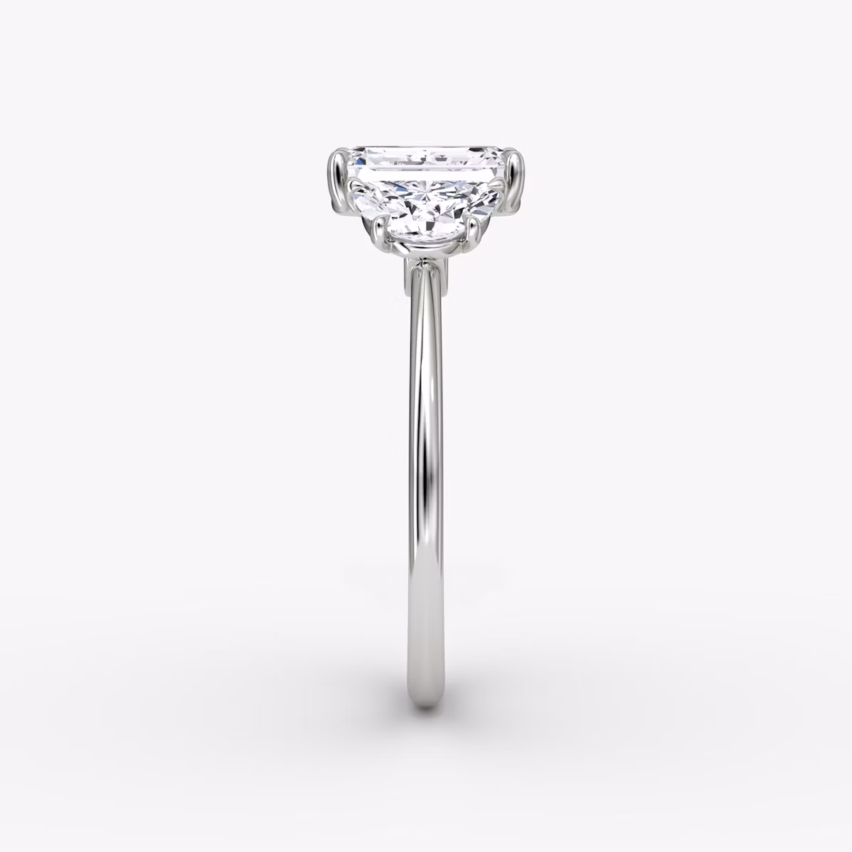 The Three Stone | Emerald | Platinum | bandAccent: Plain | sideStoneCarat: 0.50ct | sideStoneShape: Half Moon | diamondOrientation: vertical | caratWeight: other