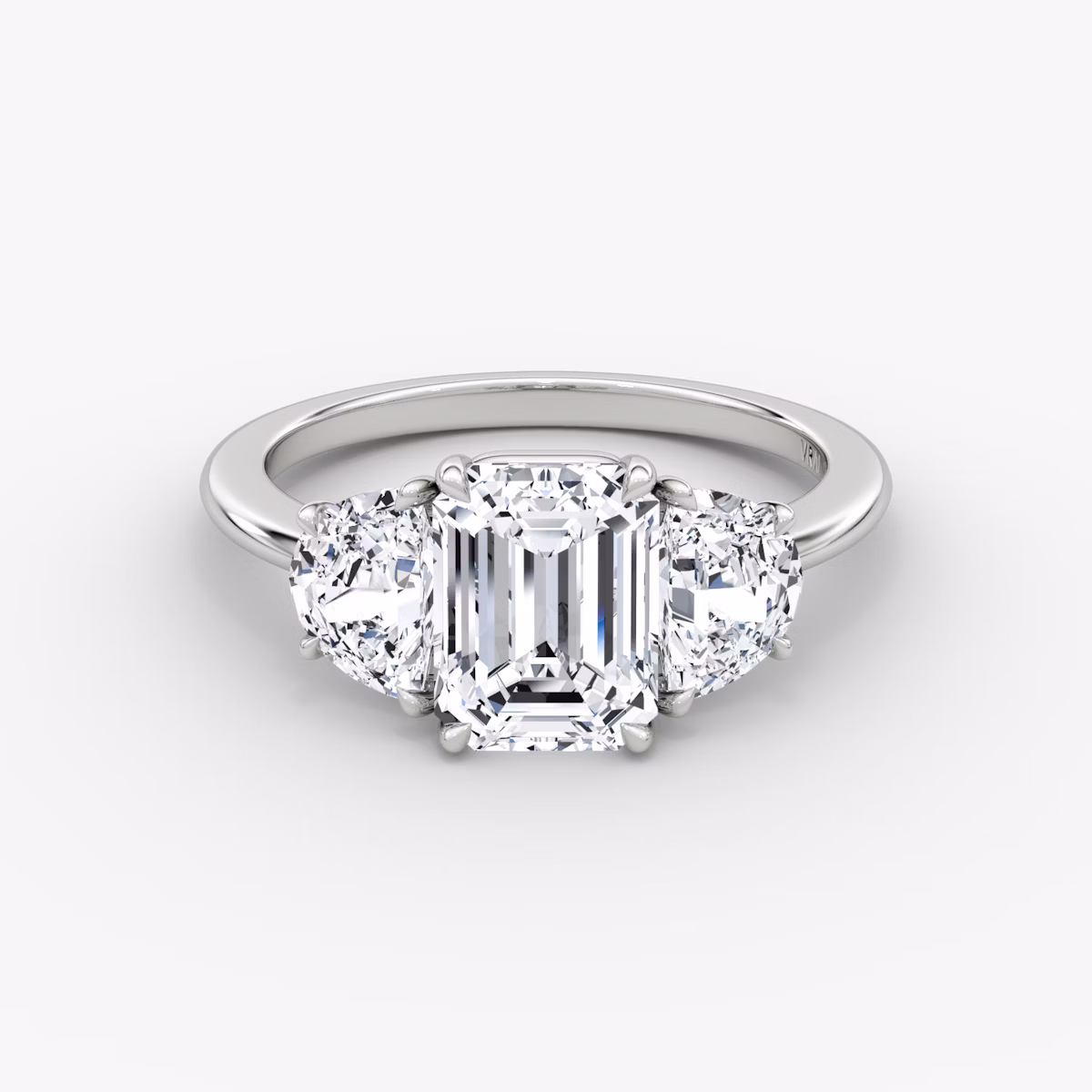The Three Stone | Emerald | Platinum | bandAccent: Plain | sideStoneCarat: 0.50ct | sideStoneShape: Half Moon | diamondOrientation: vertical | caratWeight: other