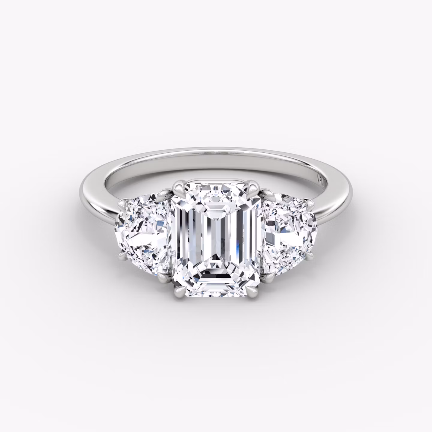 The Three Stone | Emerald | Platinum | bandAccent: Plain | sideStoneCarat: 0.50ct | sideStoneShape: Half Moon | diamondOrientation: vertical | caratWeight: other
