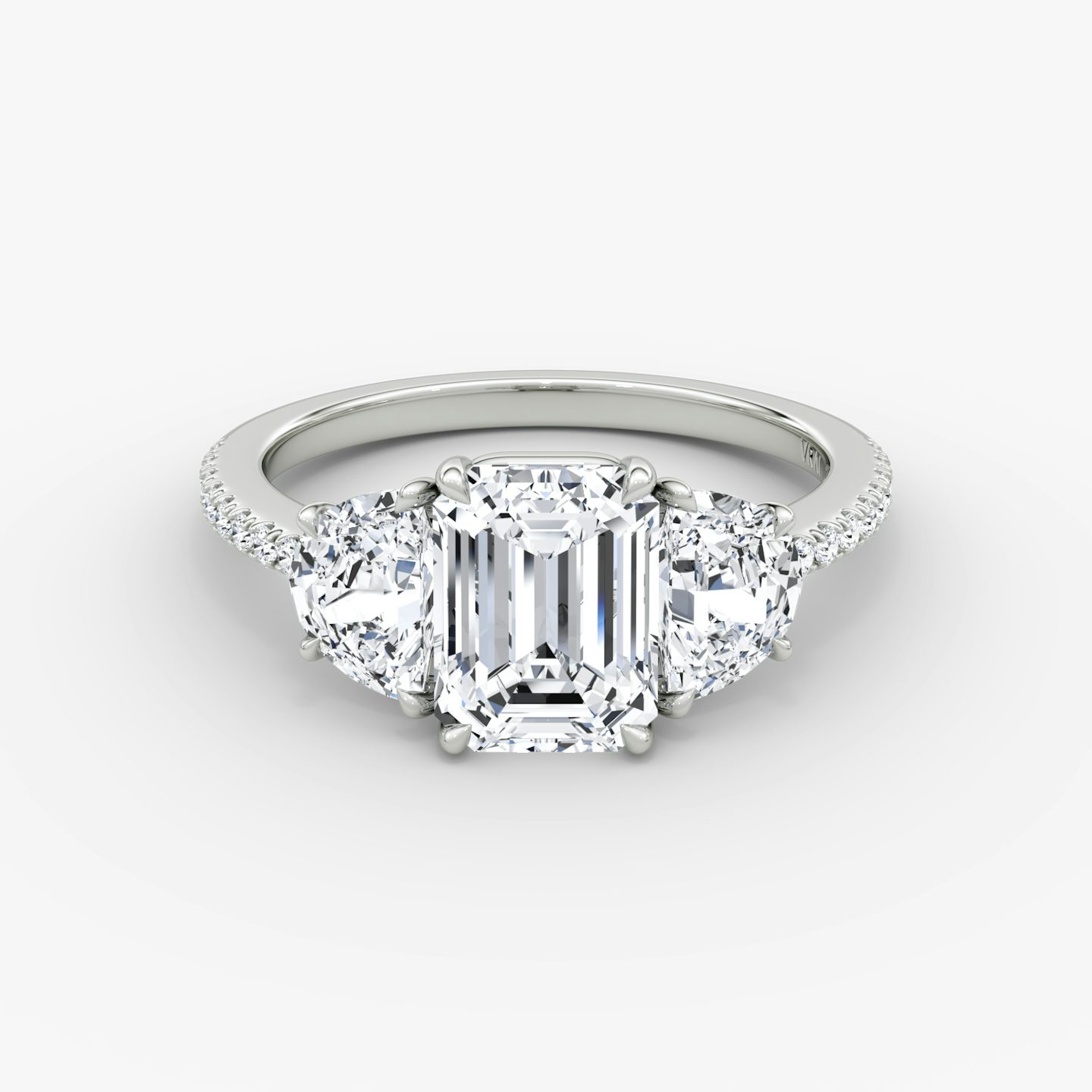 The Three Stone | Emerald | Platinum | bandAccent: Pavé | sideStoneCarat: 0.50ct | sideStoneShape: Half Moon | diamondOrientation: vertical | caratWeight: other