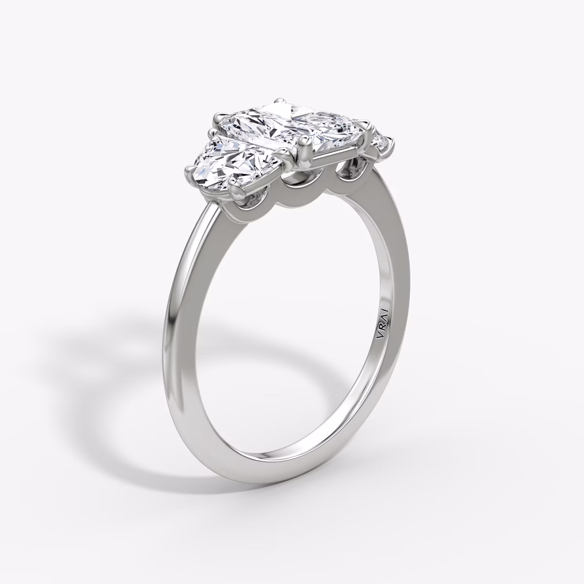The Three Stone | Radiant | Platinum | bandAccent: Plain | sideStoneCarat: 0.50ct | sideStoneShape: Half Moon | diamondOrientation: vertical | caratWeight: other