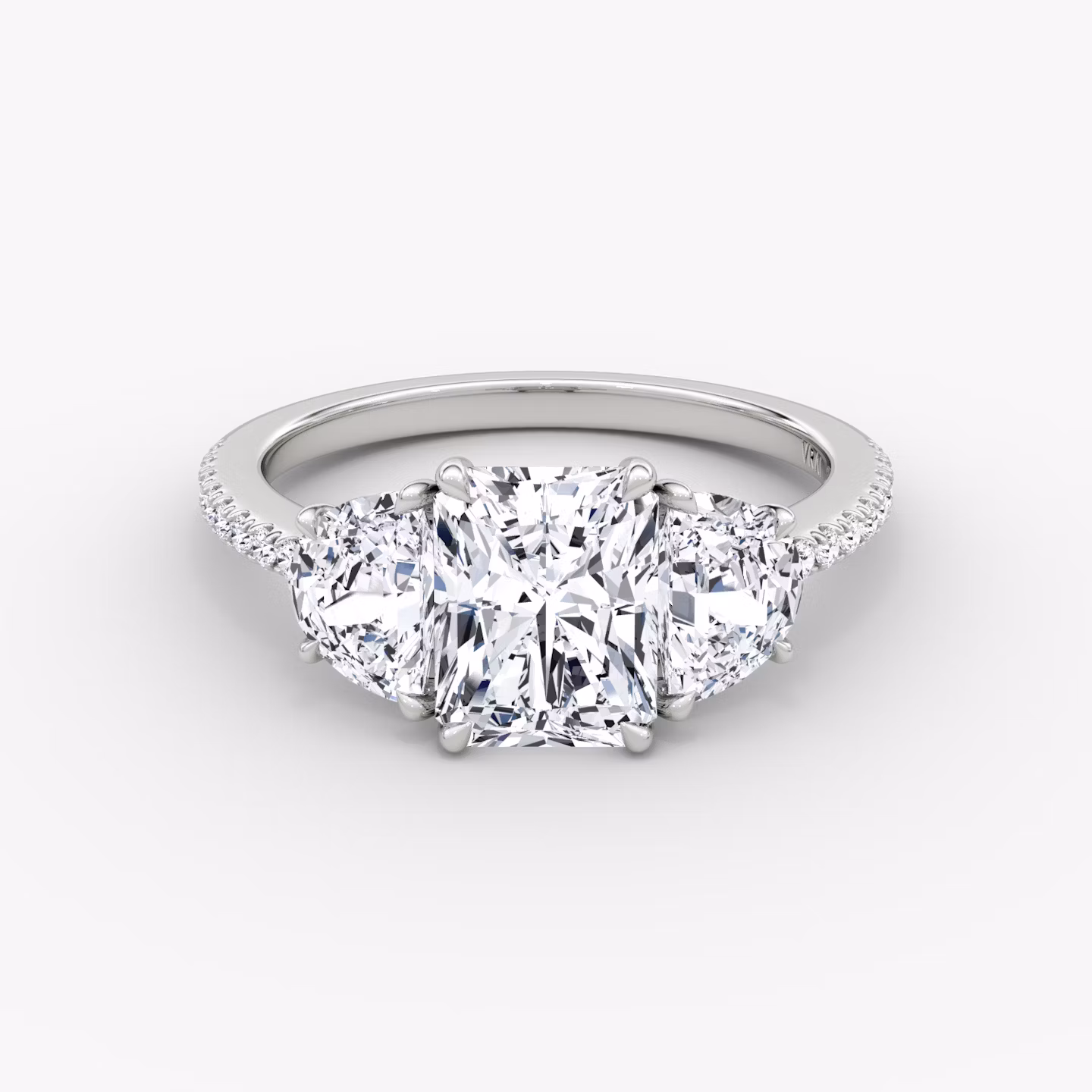 The Three Stone | Radiant | 18k | White Gold | bandAccent: Pavé | sideStoneCarat: 0.50ct | sideStoneShape: Half Moon | diamondOrientation: vertical | caratWeight: other