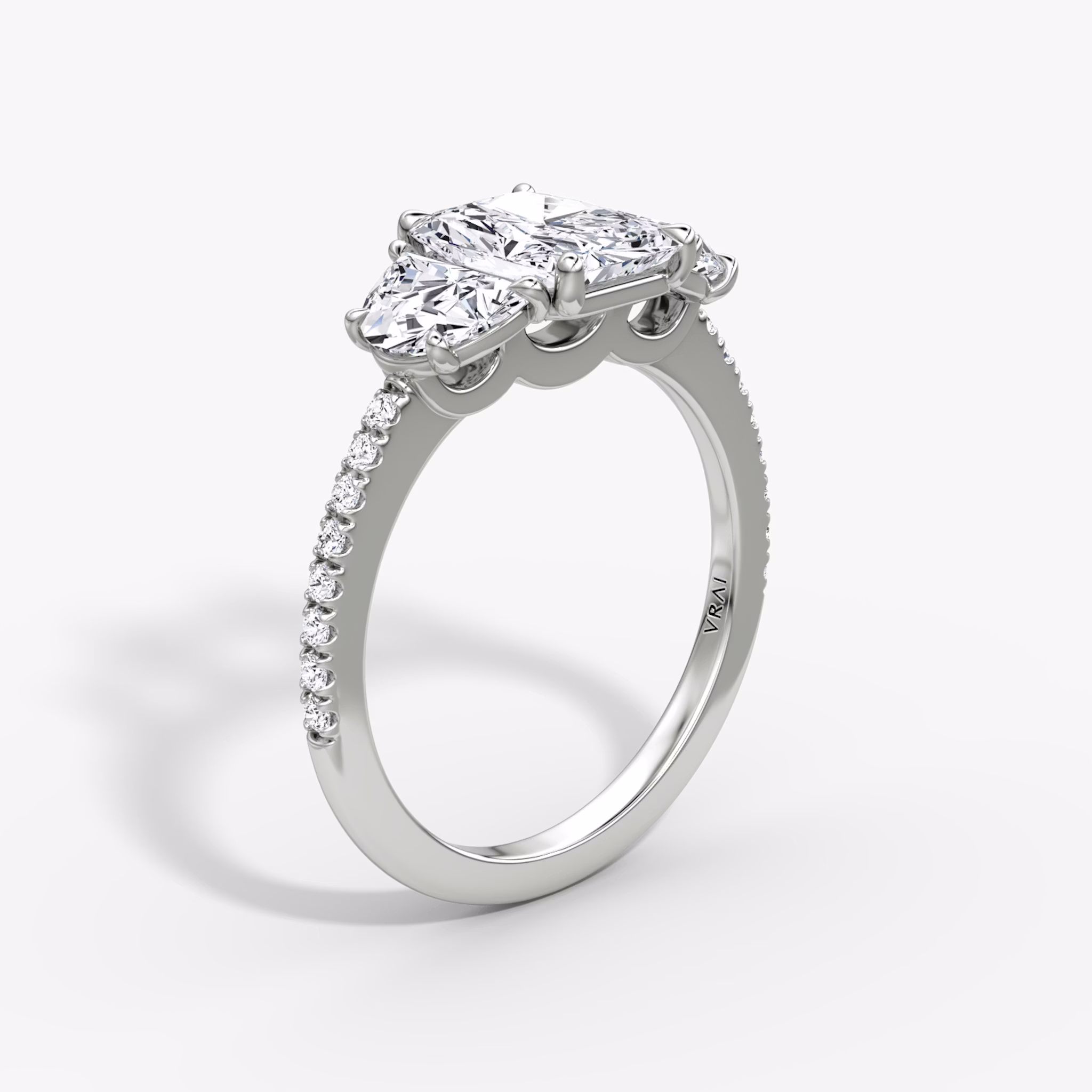 The Three Stone | Radiant | 18k | White Gold | bandAccent: Pavé | sideStoneCarat: 0.50ct | sideStoneShape: Half Moon | diamondOrientation: vertical | caratWeight: other