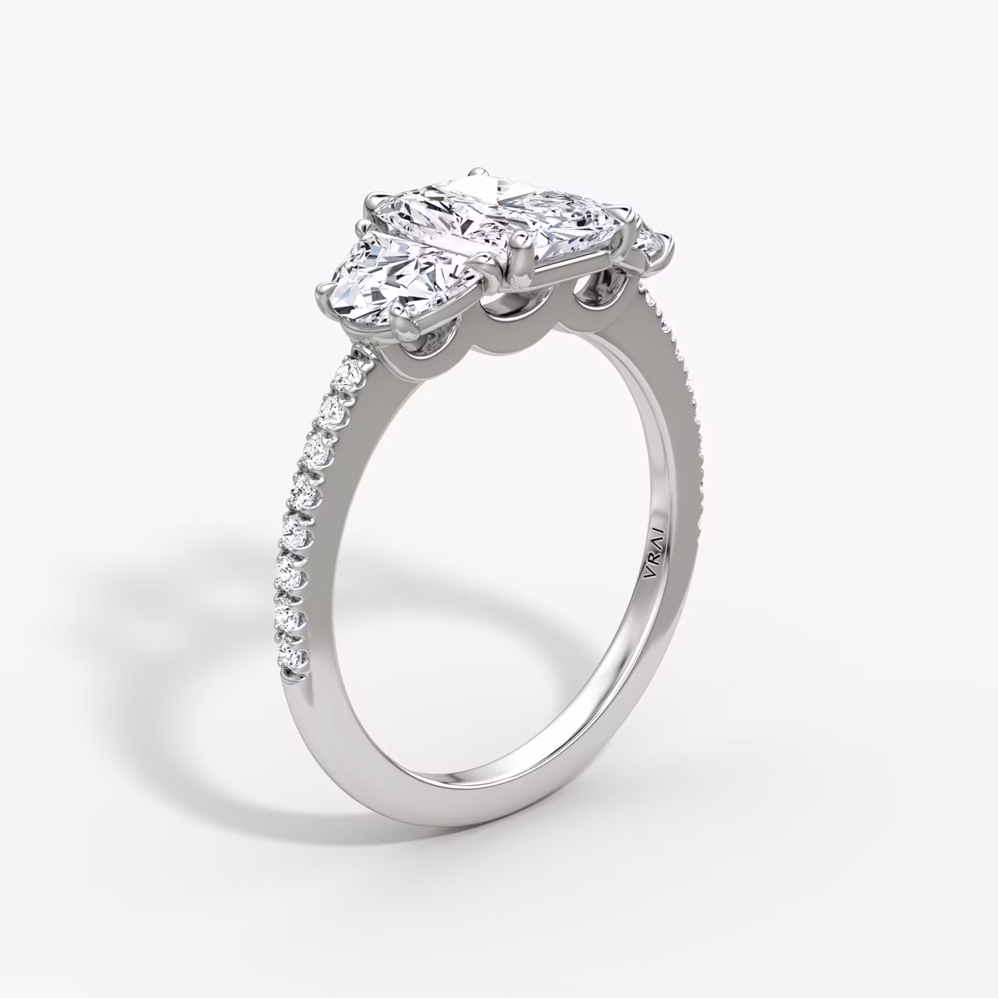 The Three Stone | Radiant | 18k | White Gold | bandAccent: Pavé | sideStoneCarat: 0.50ct | sideStoneShape: Half Moon | diamondOrientation: vertical | caratWeight: other
