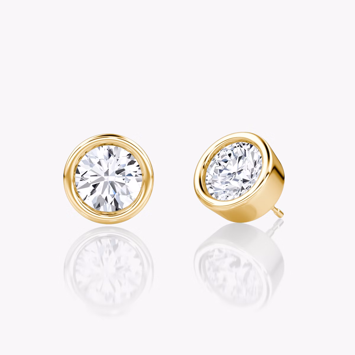 Three-quarter view of round bezel-set solitaire stud earring in yellow gold, 1.00 ct design.