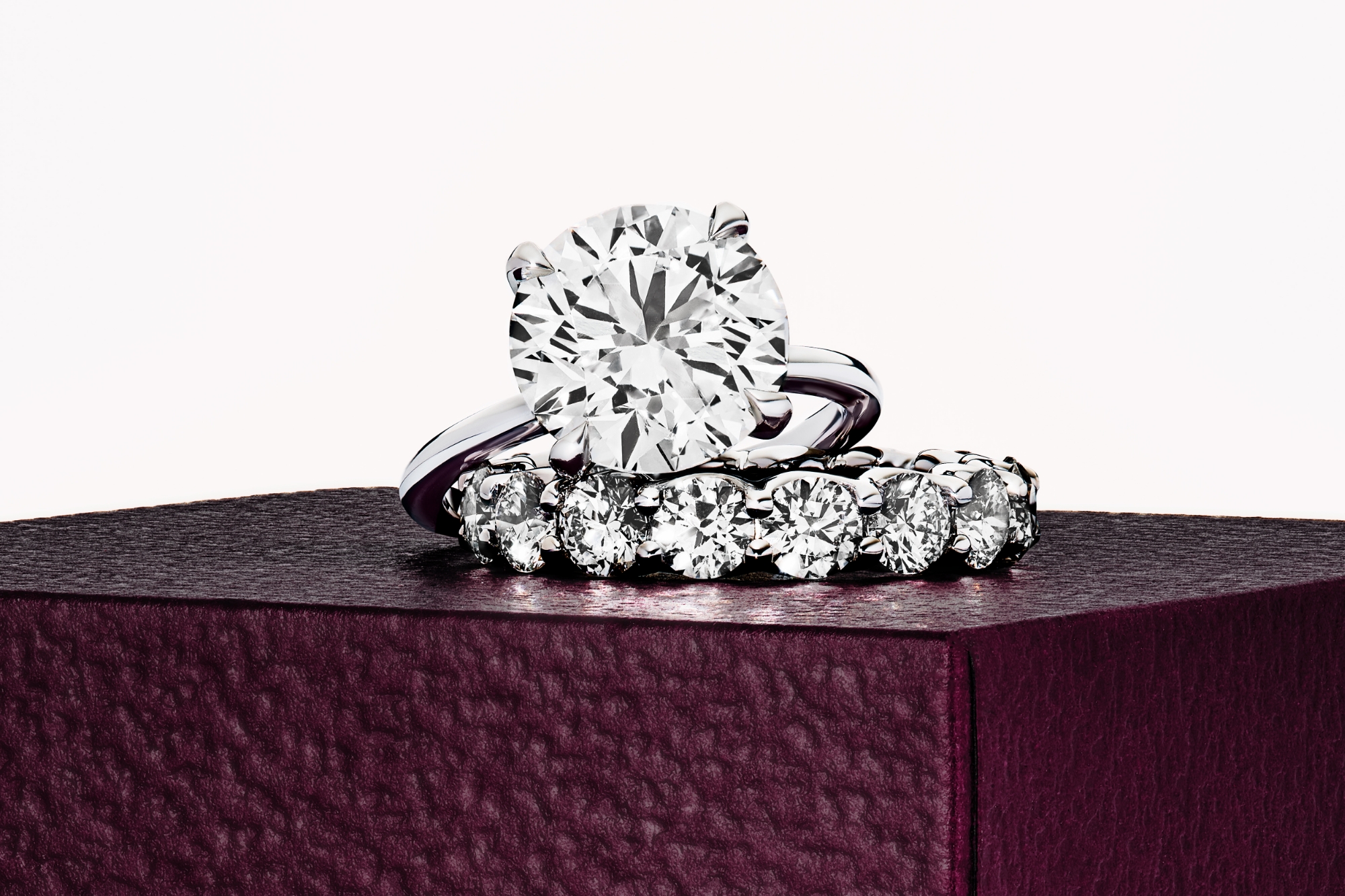 engagement ring in platinum with a round brilliant cut and pave wedding band