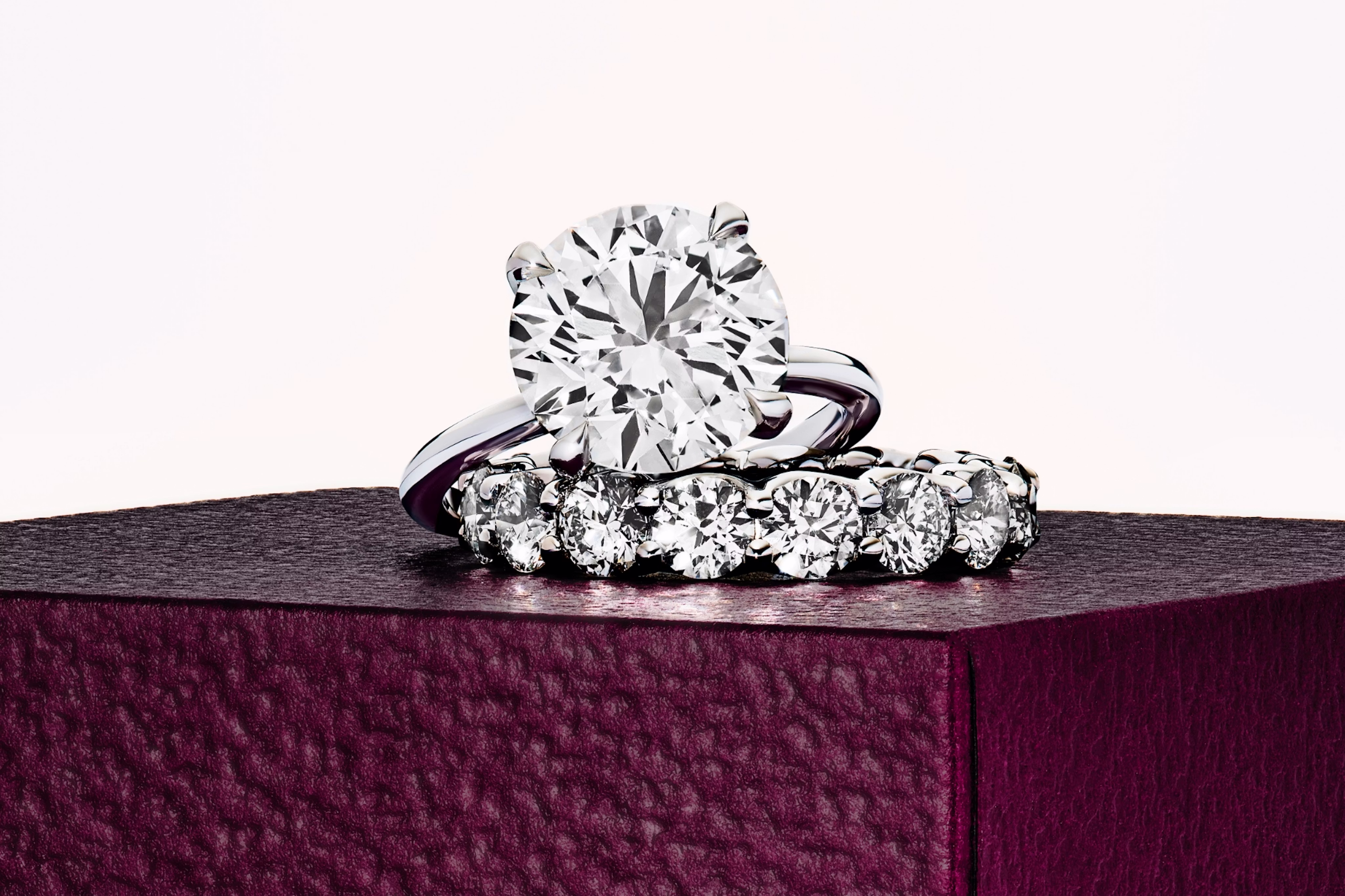 engagement ring in platinum with a round brilliant cut and pave wedding band