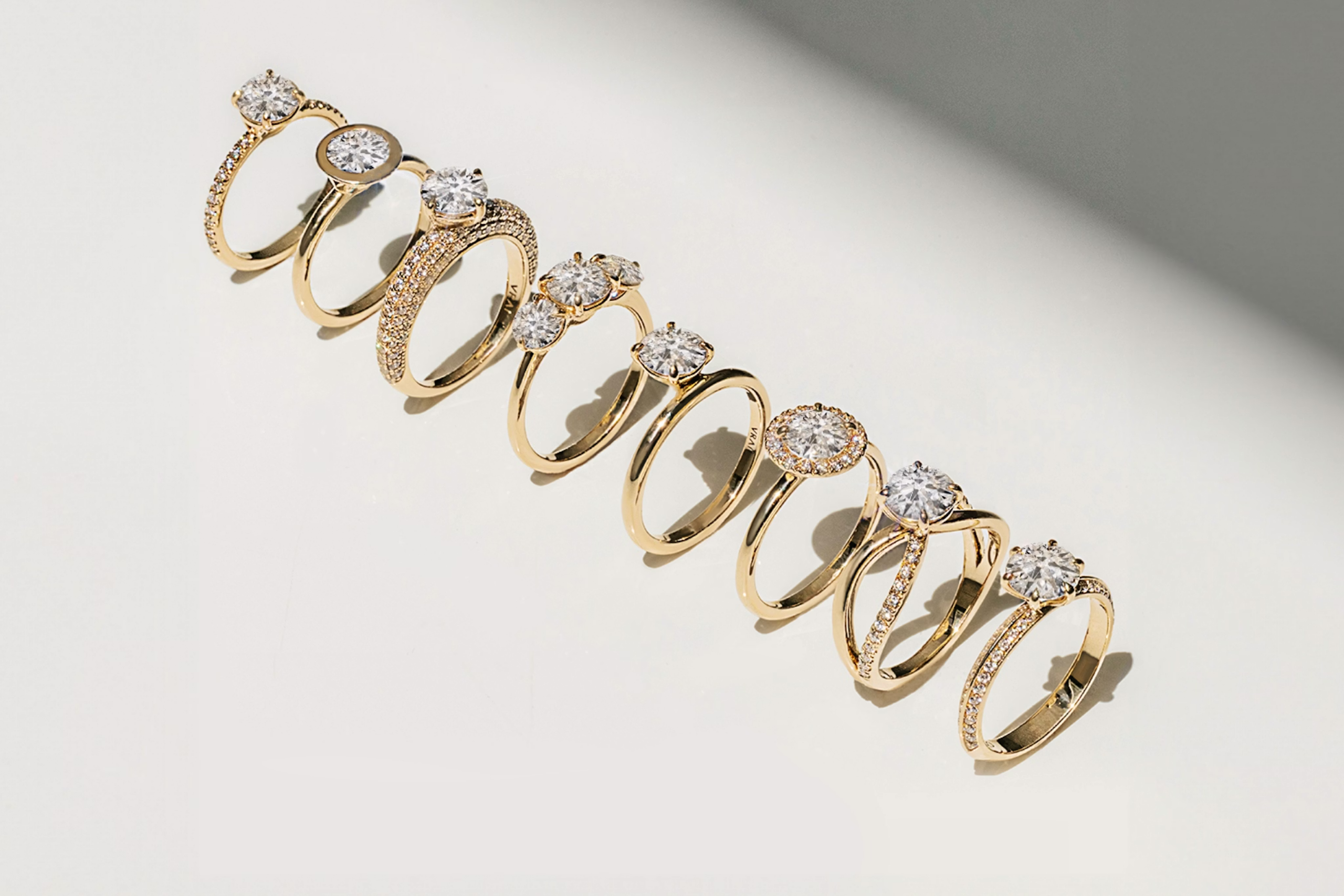 eight different engagement rings with different diamond shapes and different settings from solitaire to three stone and with pave bands