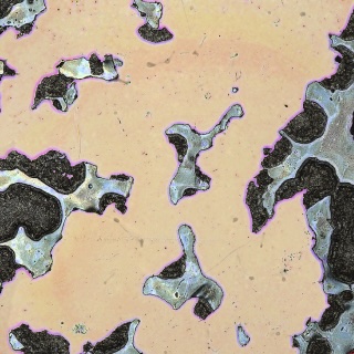 An abstract, textured surface featuring pale yellow and beige hues with irregular, jagged edges highlighted in vibrant purple, blue, and black.