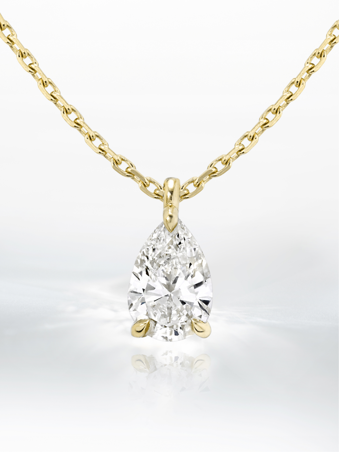 A close-up image of a golden chain with a diamond pendant.