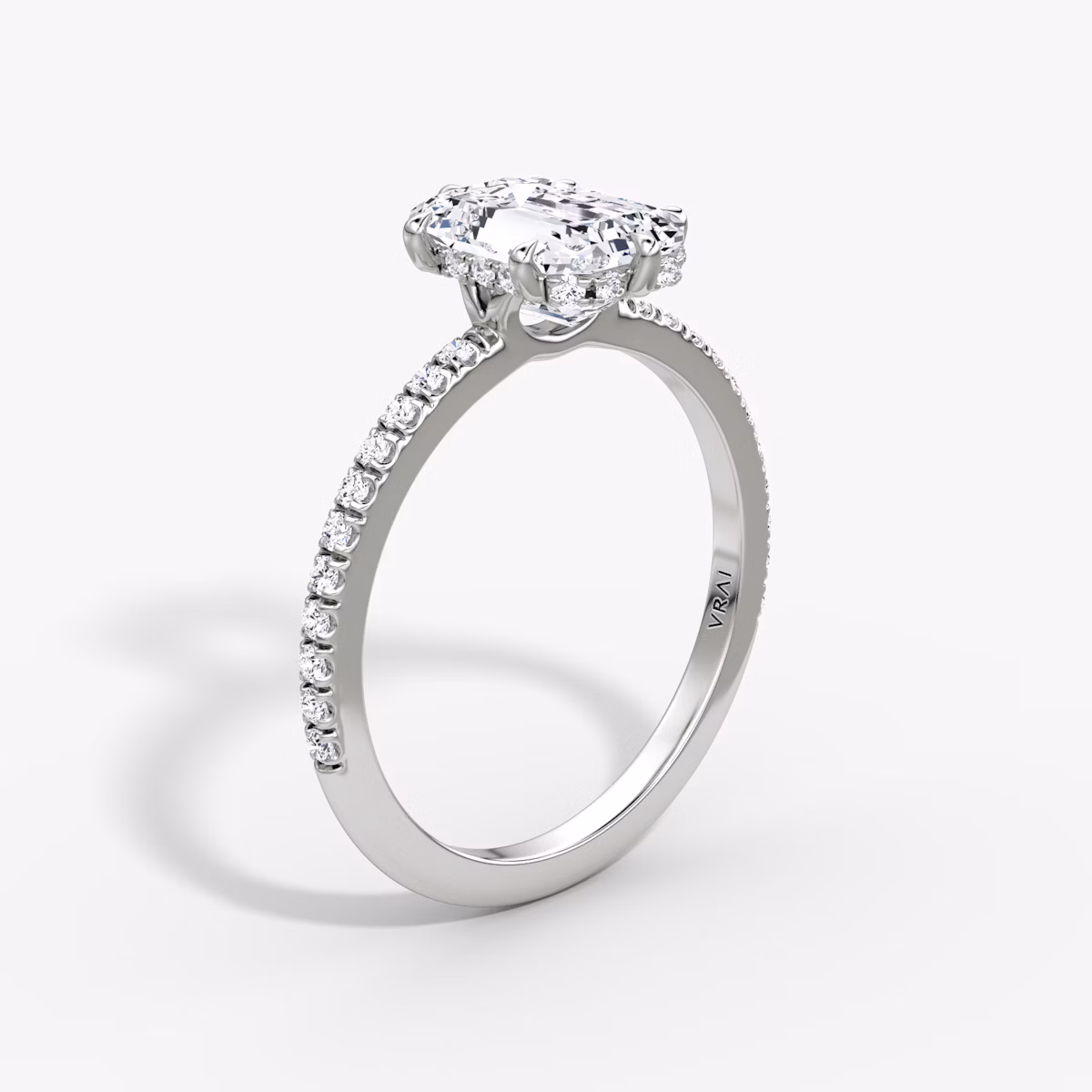 The Signature 6 Prong | Emerald | Platinum | bandAccent: Pavé | bandWidth: standard | hiddenHalo: yes | diamondOrientation: vertical | caratWeight: other