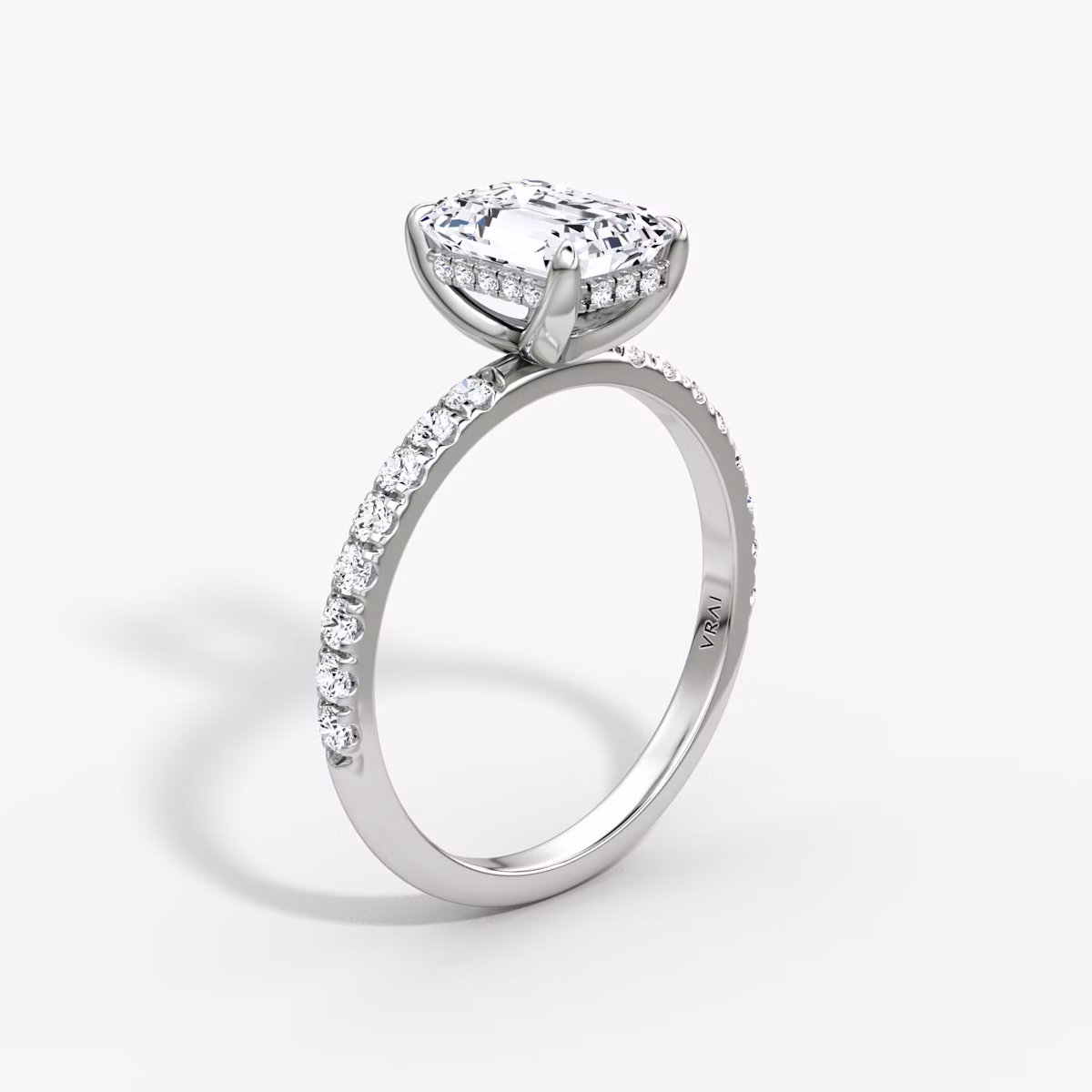 The Classic Hidden Halo | Emerald | Platinum | bandAccent: Pavé | bandWidth: large | prongStyle: Plain | diamondOrientation: vertical | caratWeight: other