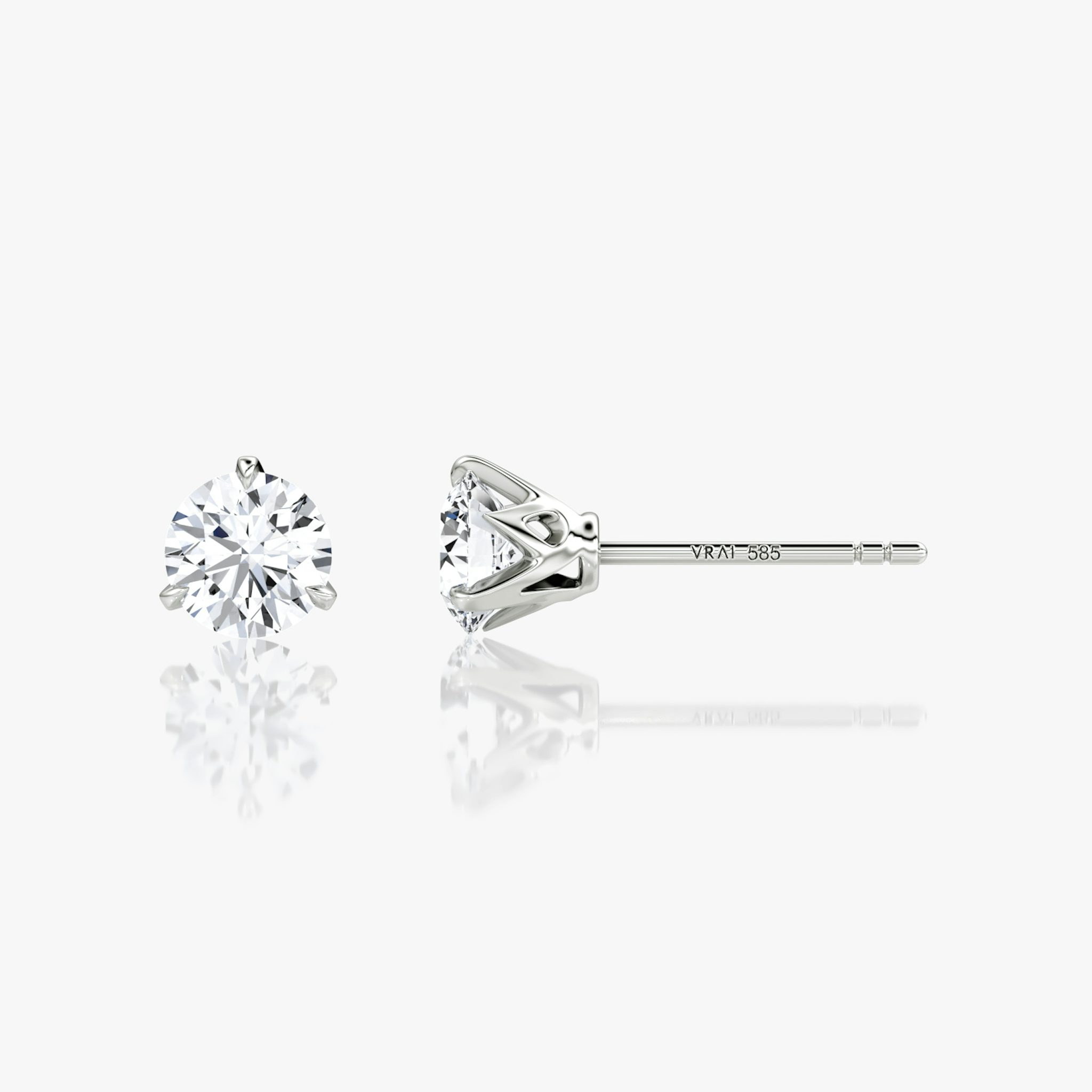 0.75ct round brilliant V-stud earring in white gold, showcasing modern prong design in fine jewelry close-up.